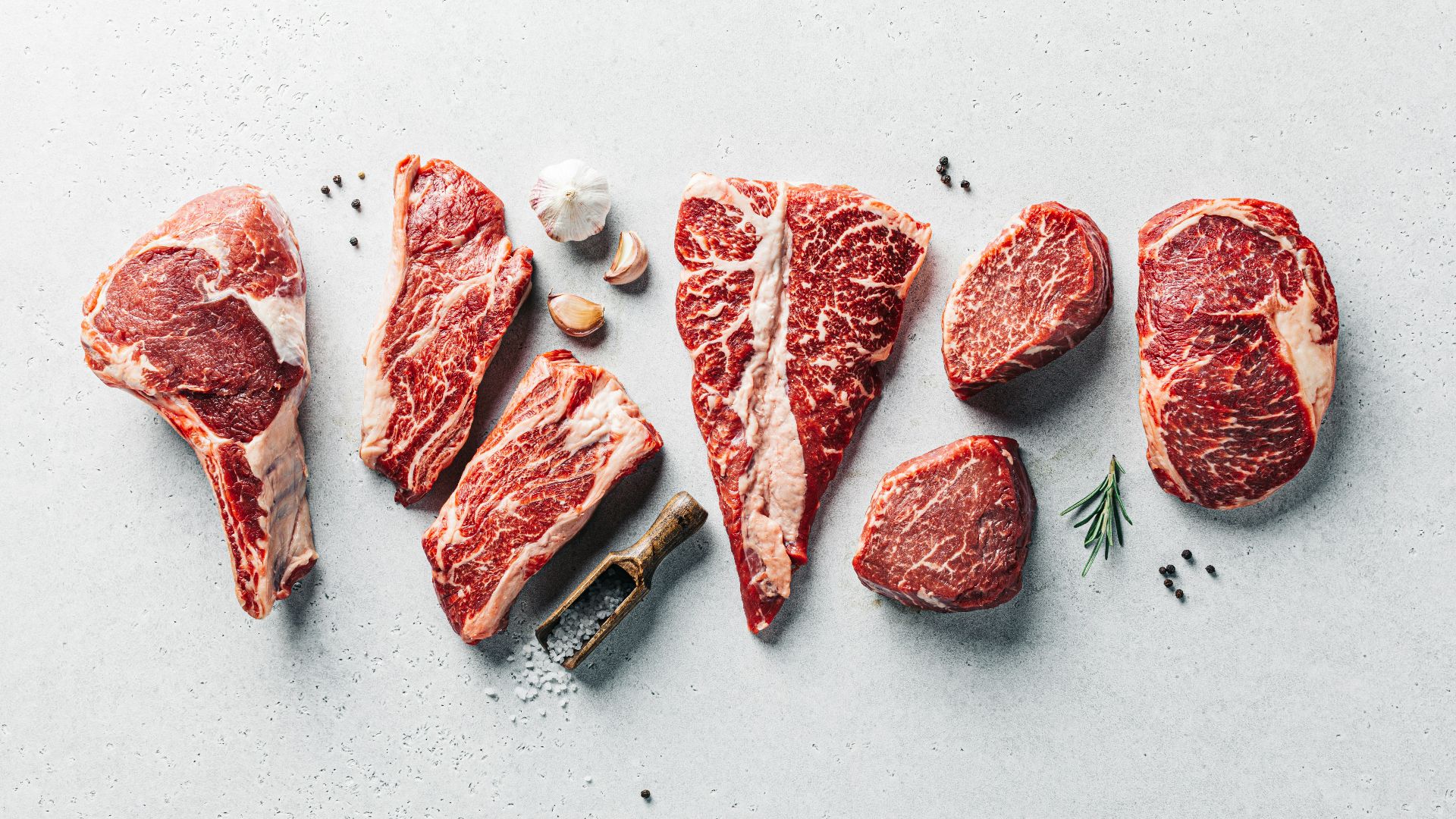 a group of raw meats on a table