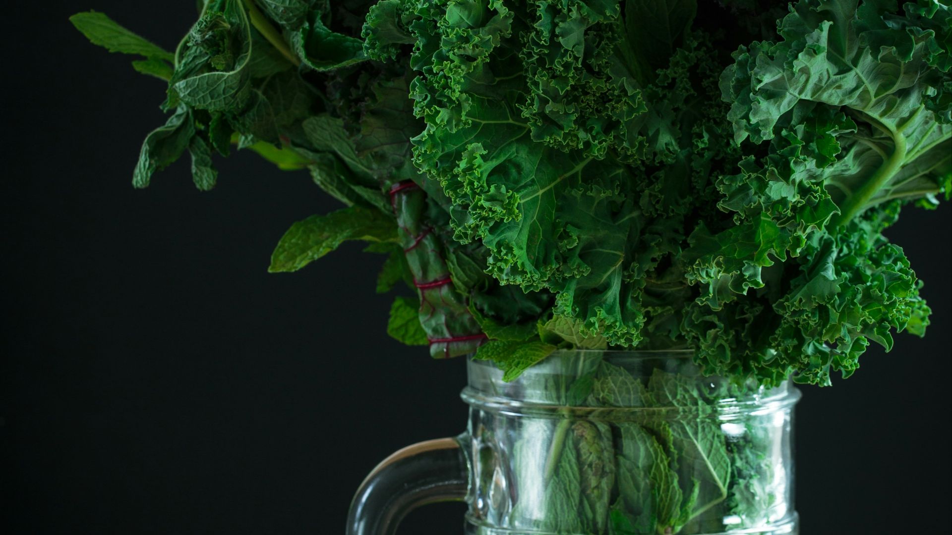 green vegetables on clear glass pitcher