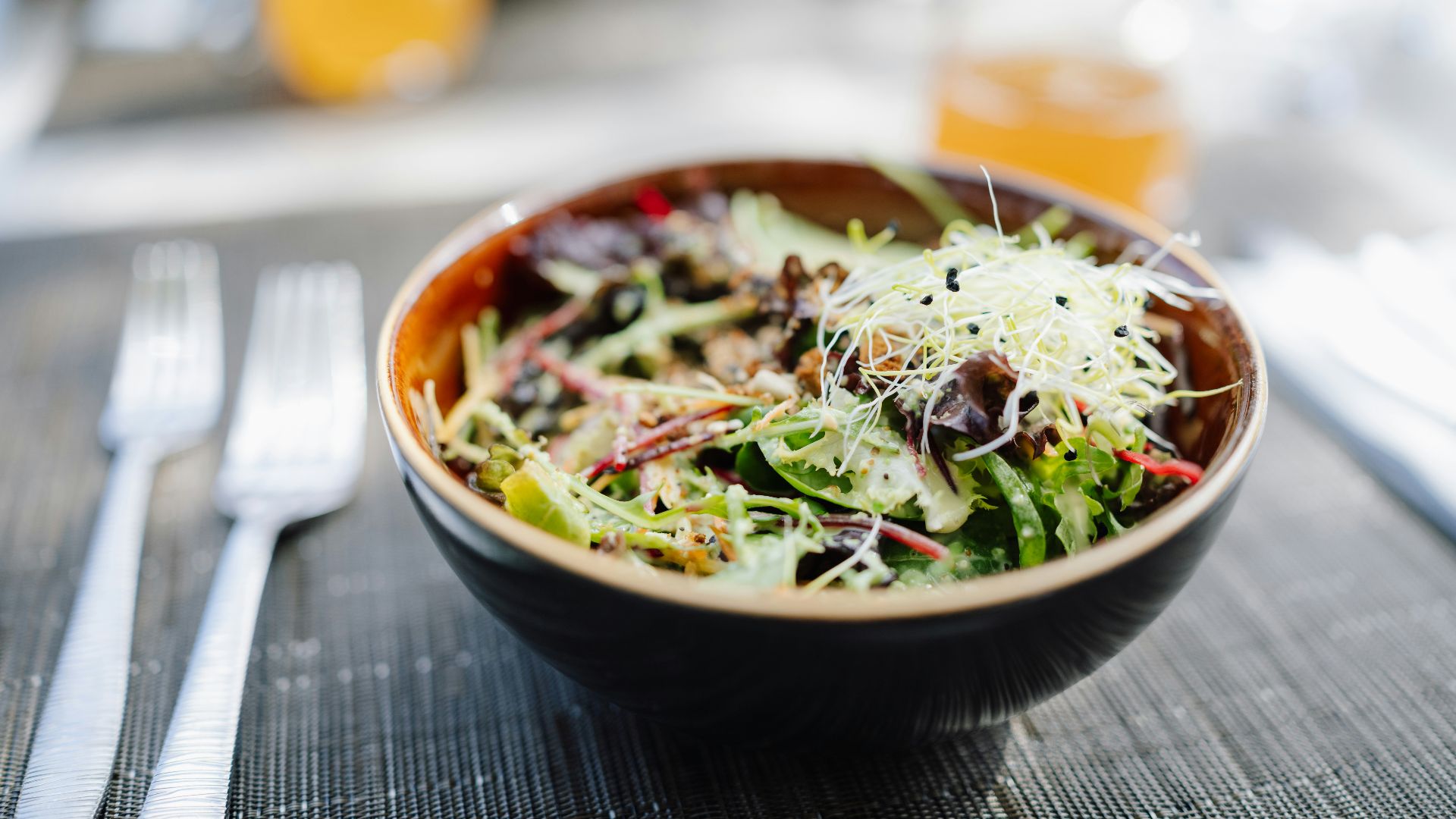 A fresh salad in a bowl on a wooden table.