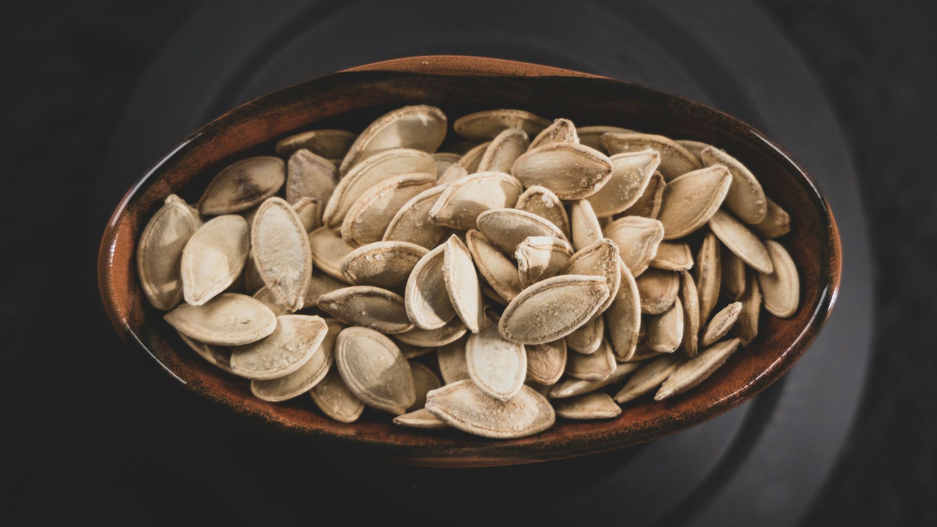 brown and white nuts on brown ceramic bowl