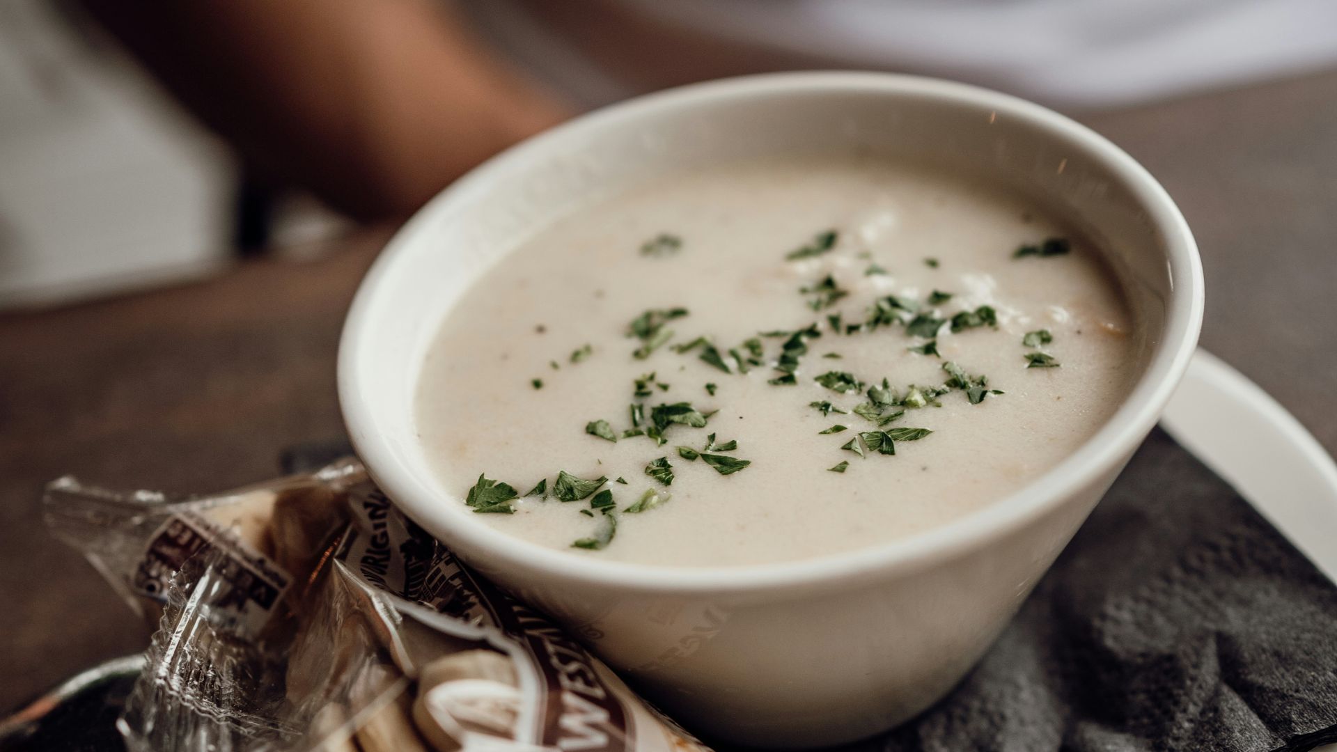 A bowl of soup sitting on top of a white plate