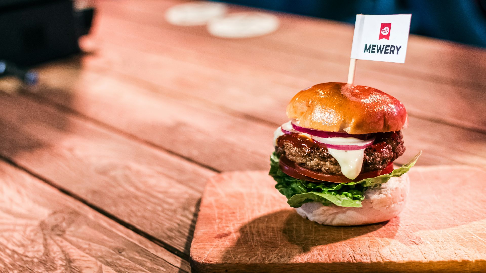 a hamburger sitting on top of a wooden cutting board
