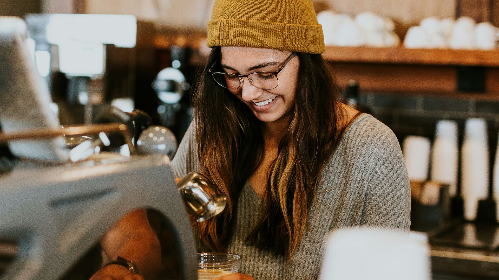 woman holding clear drinking glass