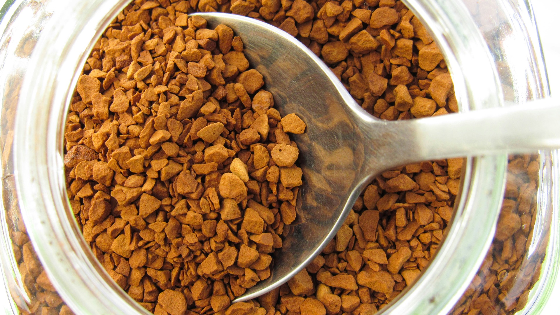 a spoon in a jar filled with dog food