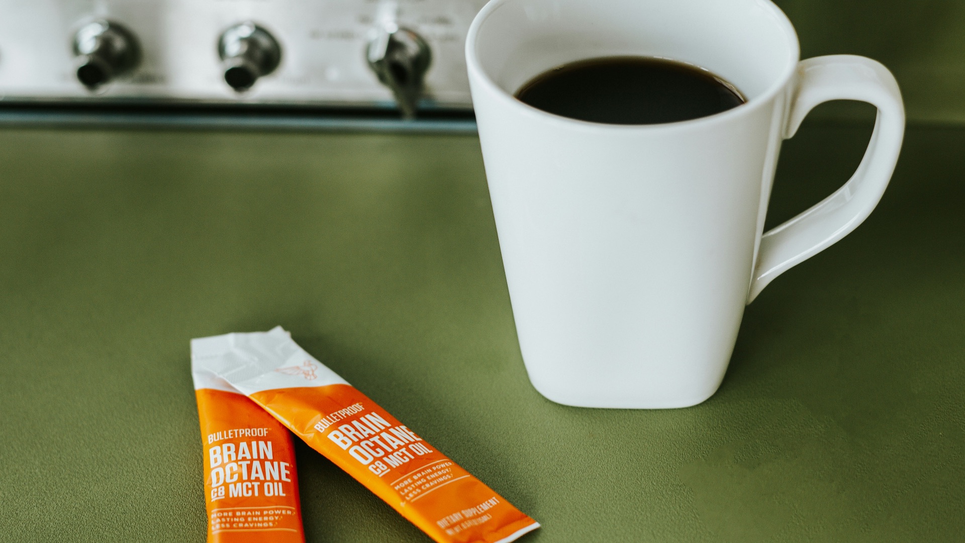 a cup of coffee next to two bars of chocolate