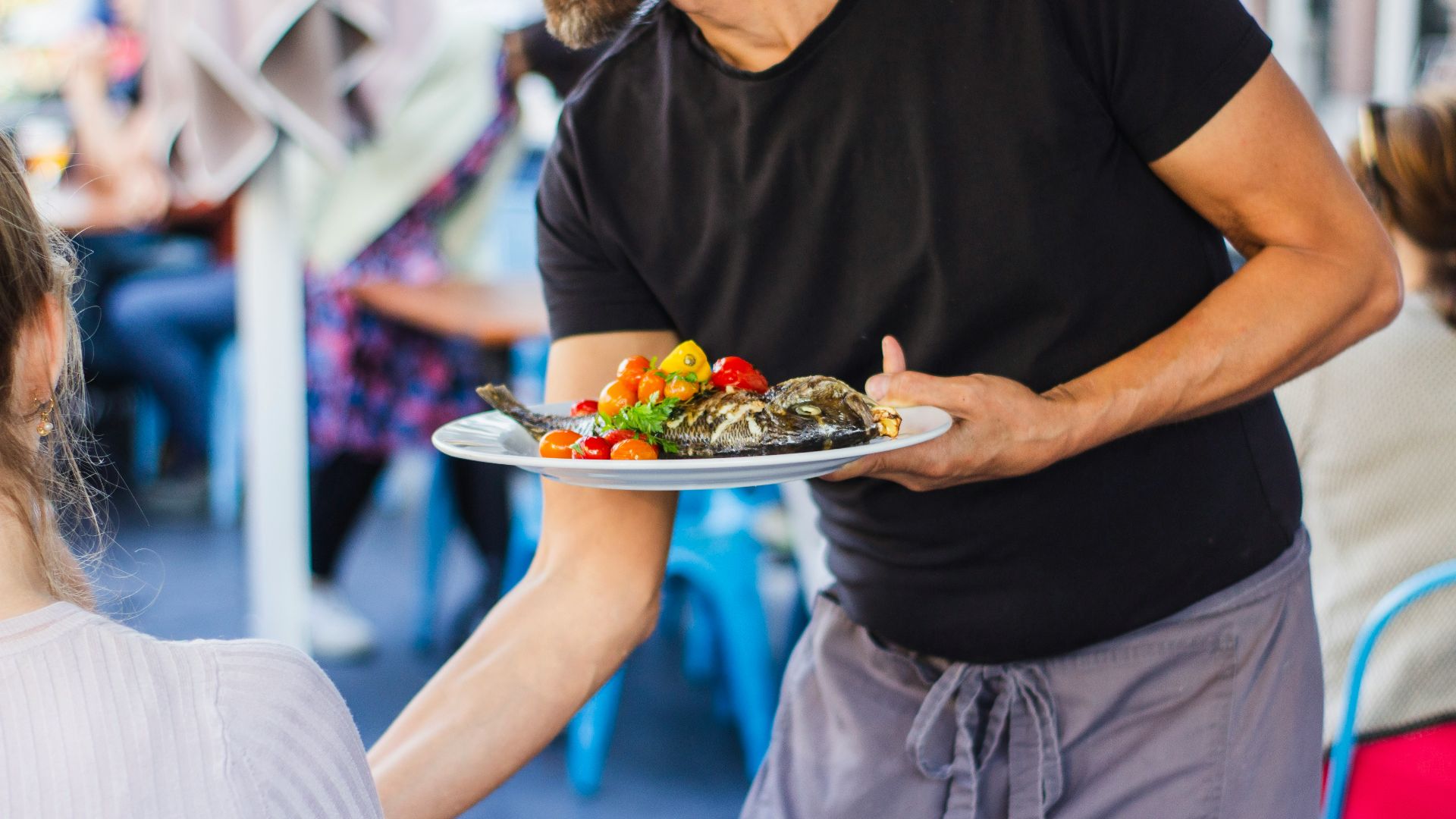 man standing and holding plate