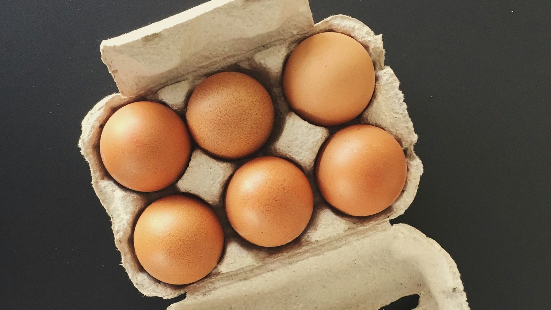 six brown fowl eggs in tray