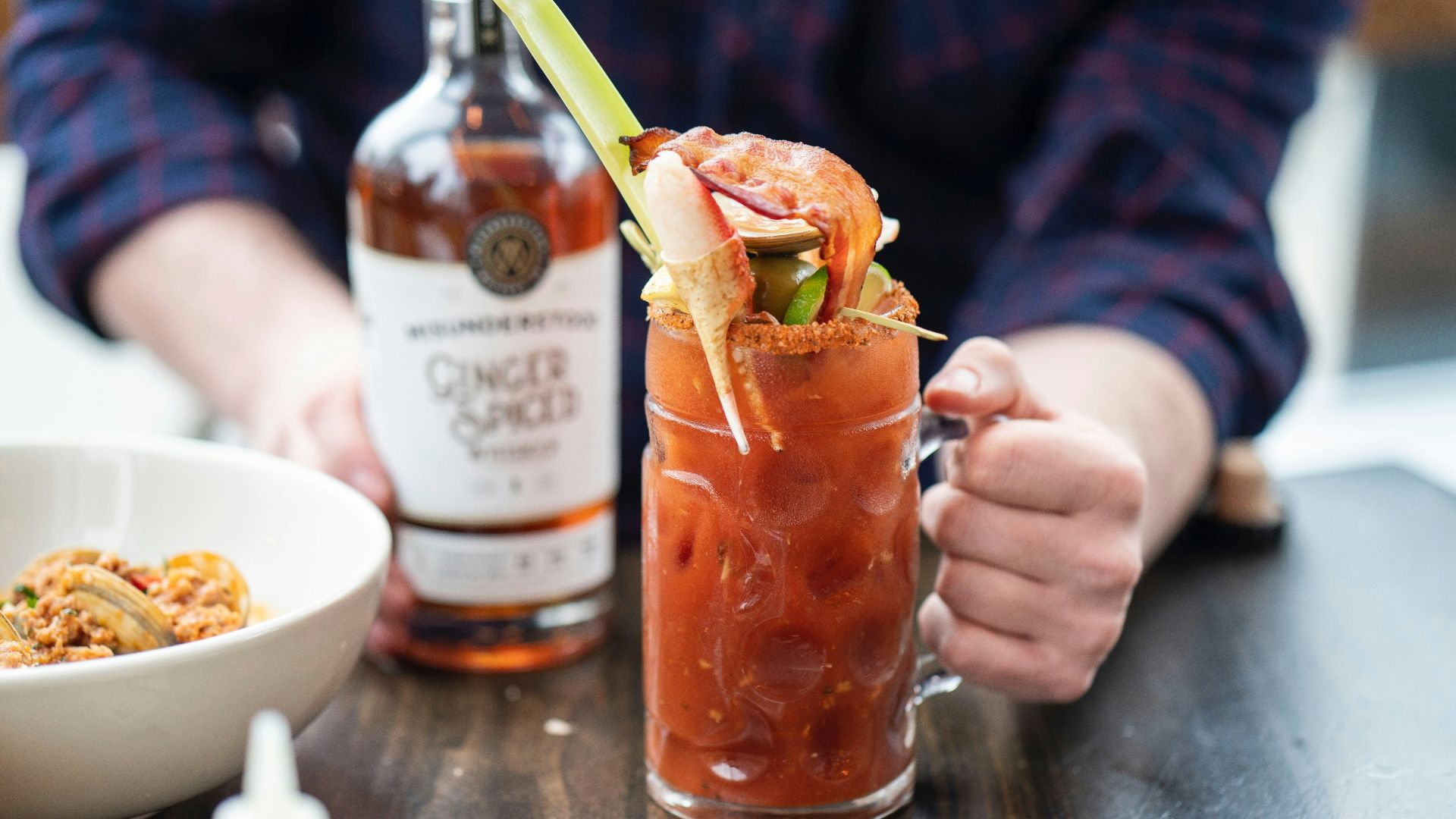 clear drinking glass with brown liquid and ice cubes
