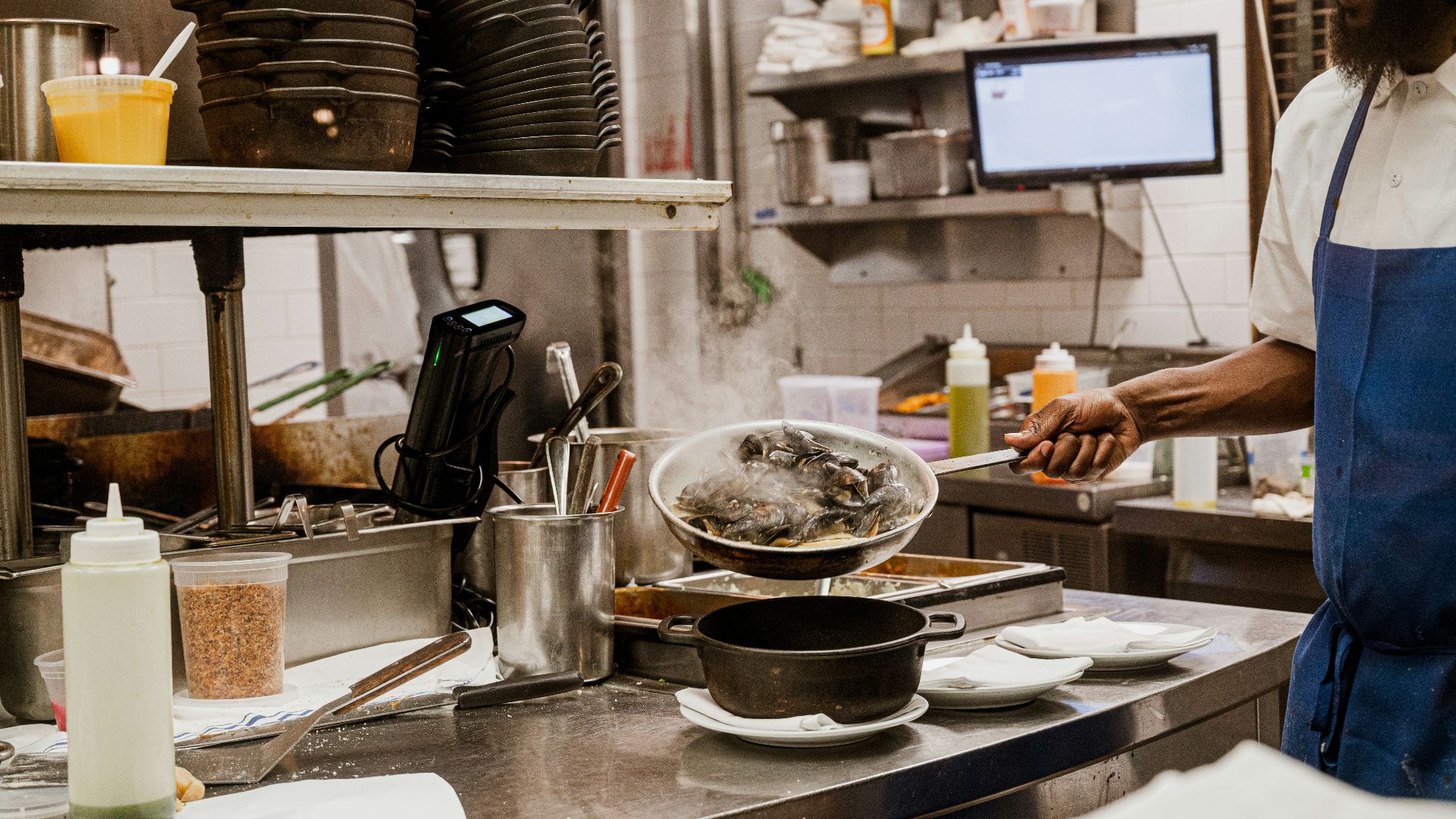 a man standing in a kitchen preparing food