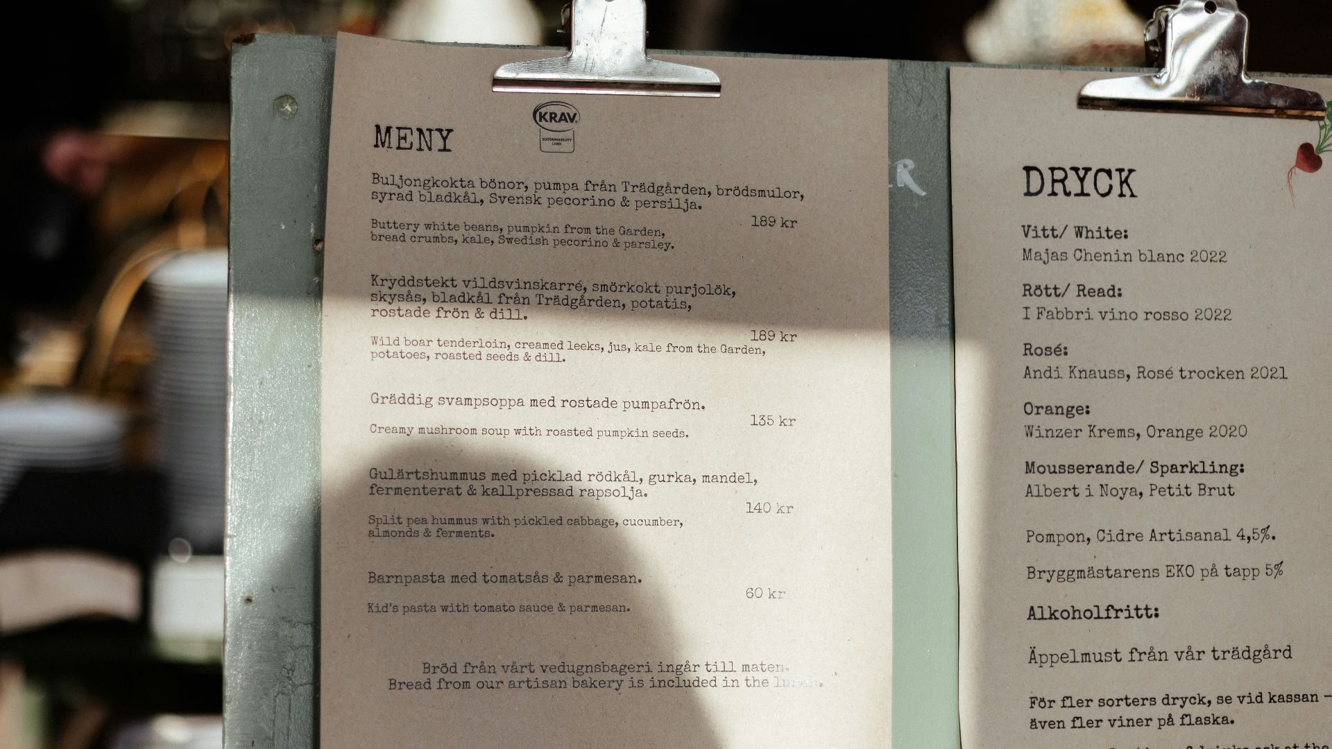 A menu sitting on top of a table next to a cup of coffee