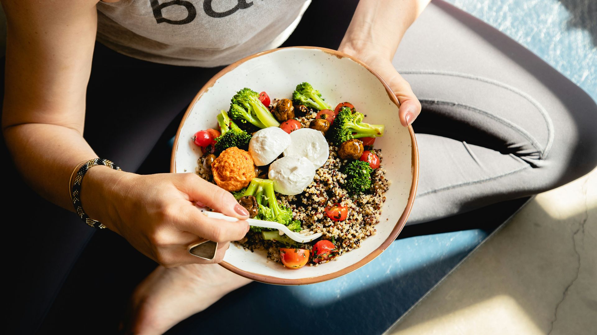 a woman is holding a bowl of food