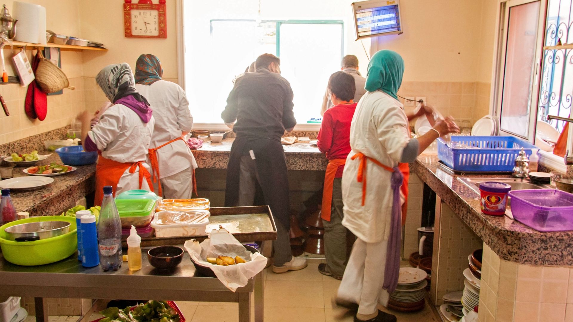 File:Amal Women's Training Center and Moroccan Restaurant trainees preparing lunch with the staff chef.jpg
