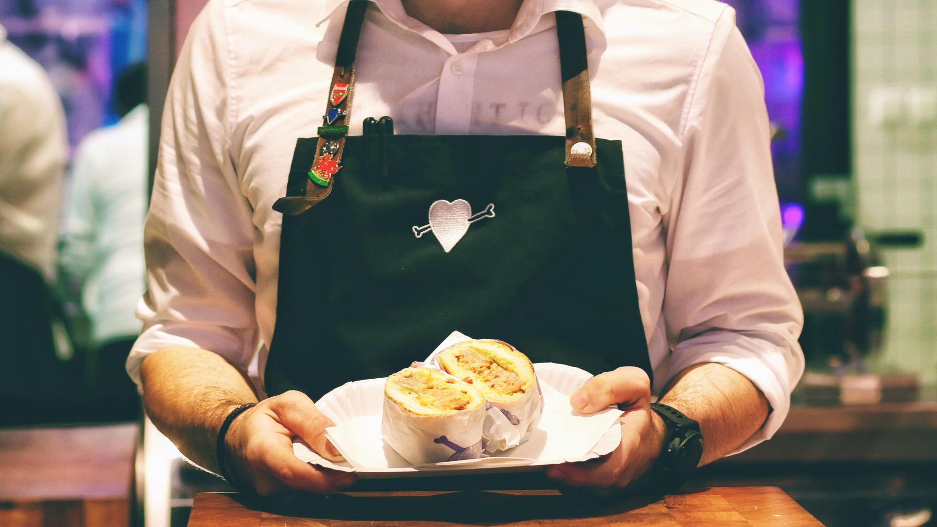 man holding fish dish on plate