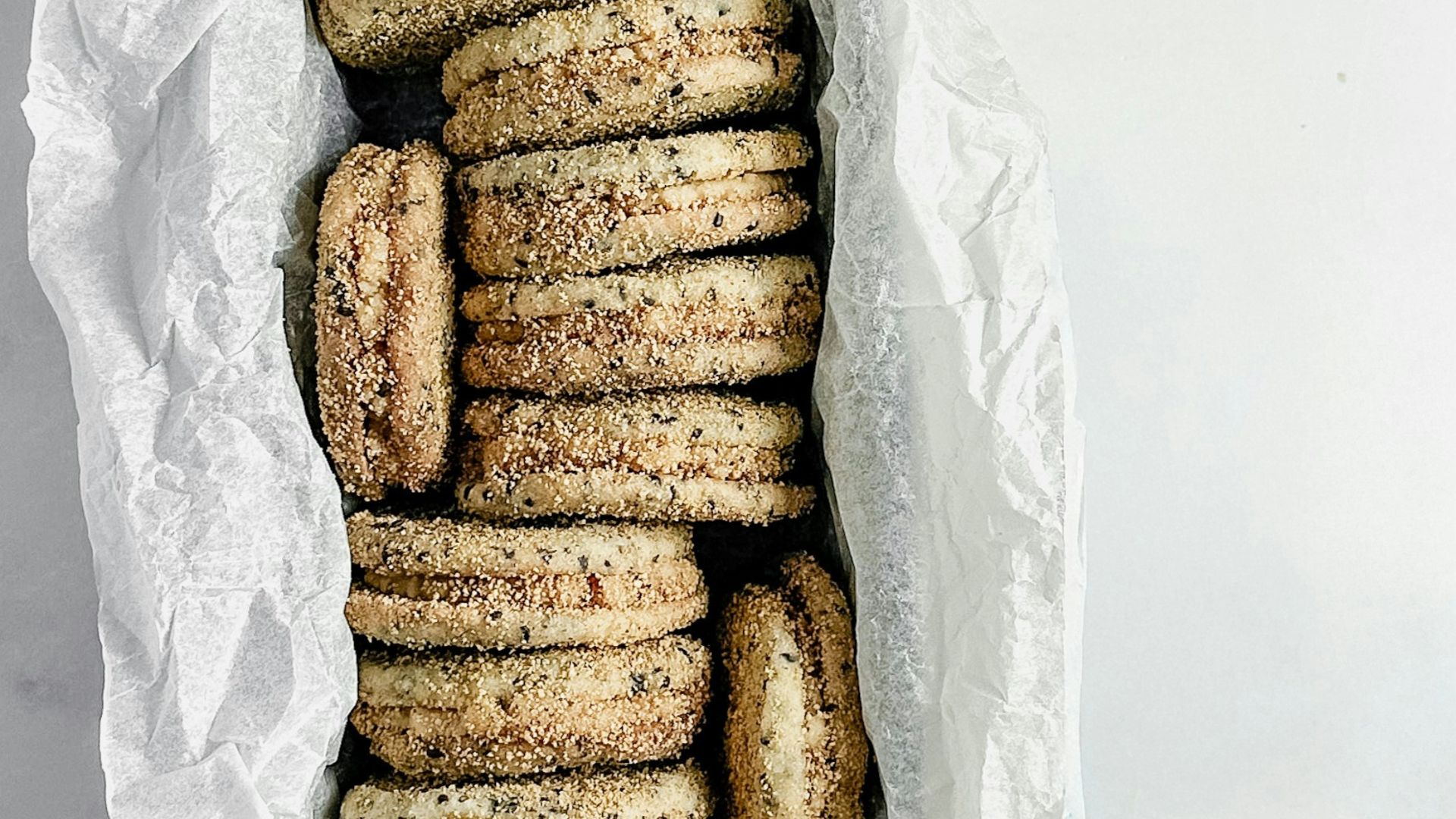 Stack of sandwich cookies in a metal tin