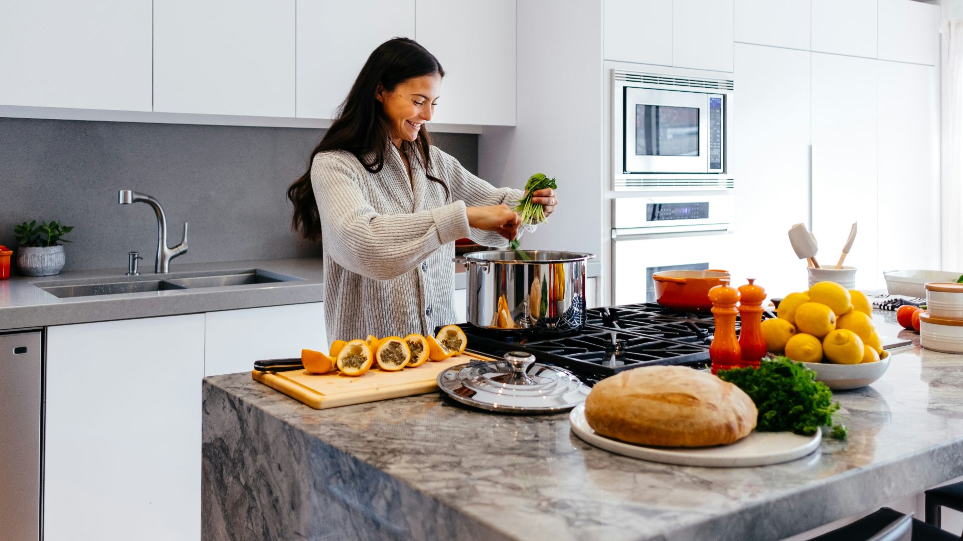 woman smiling while cooking