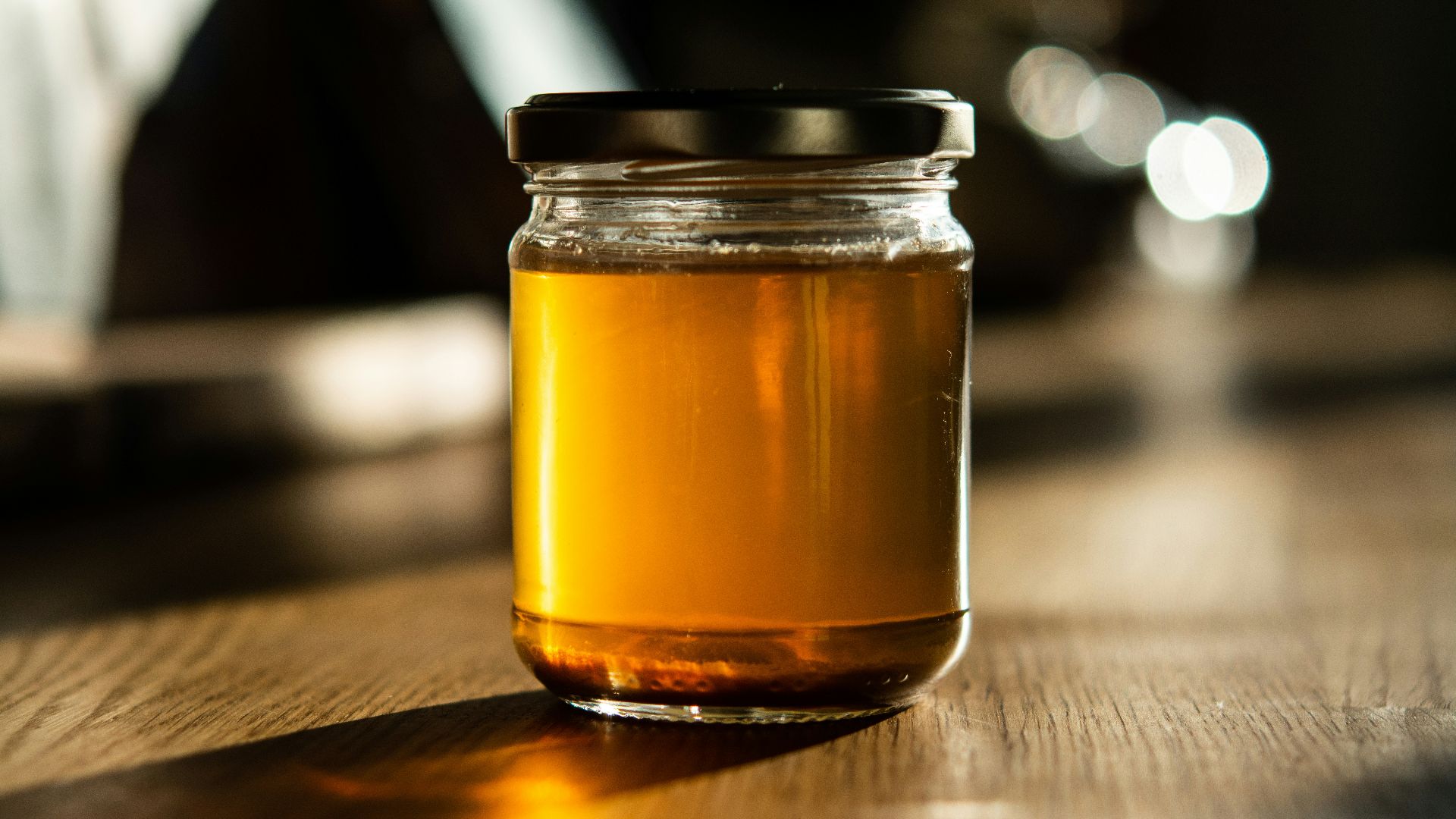 clear glass jar with brown liquid inside