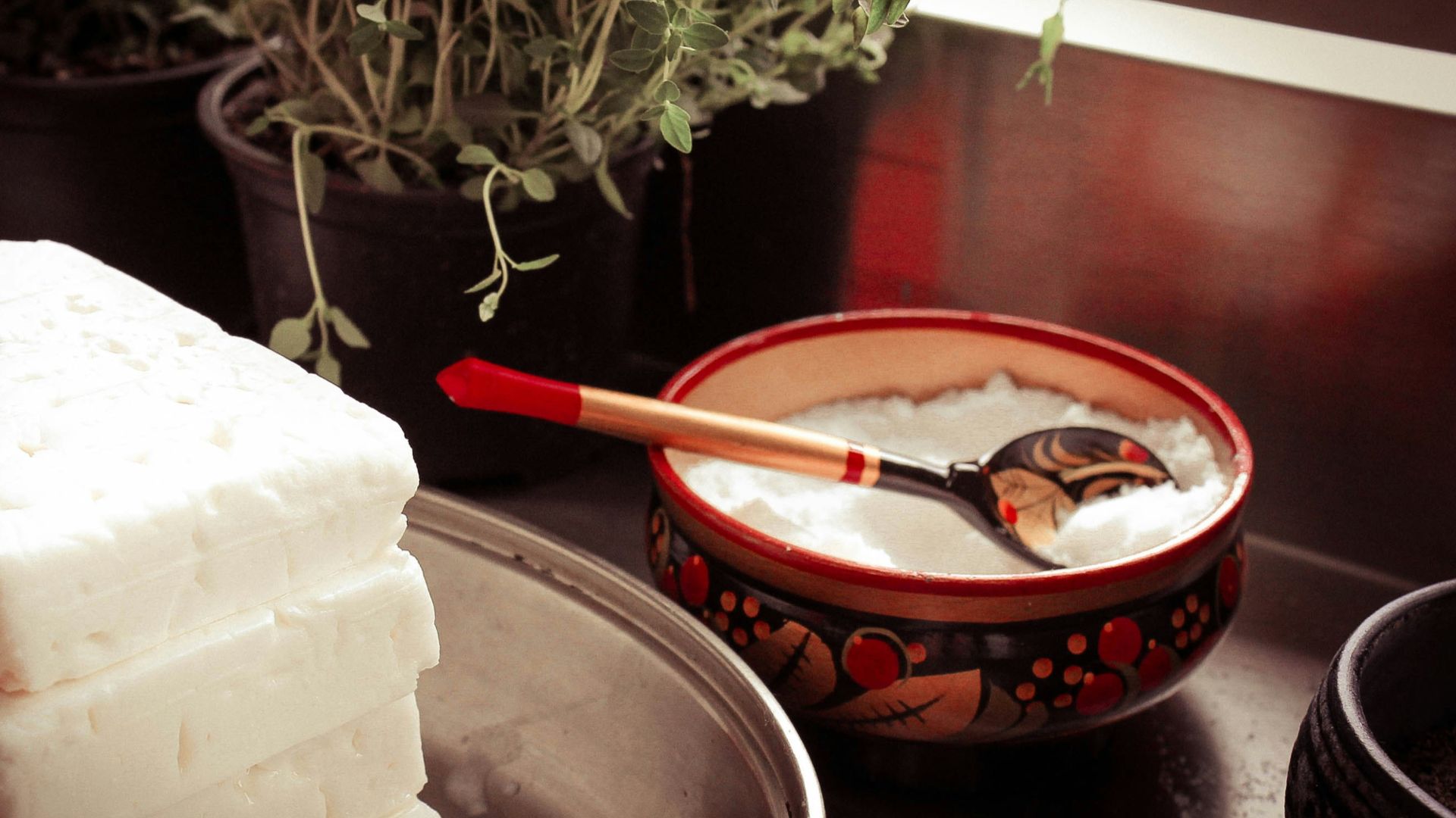 red ceramic bowl on gray spoon