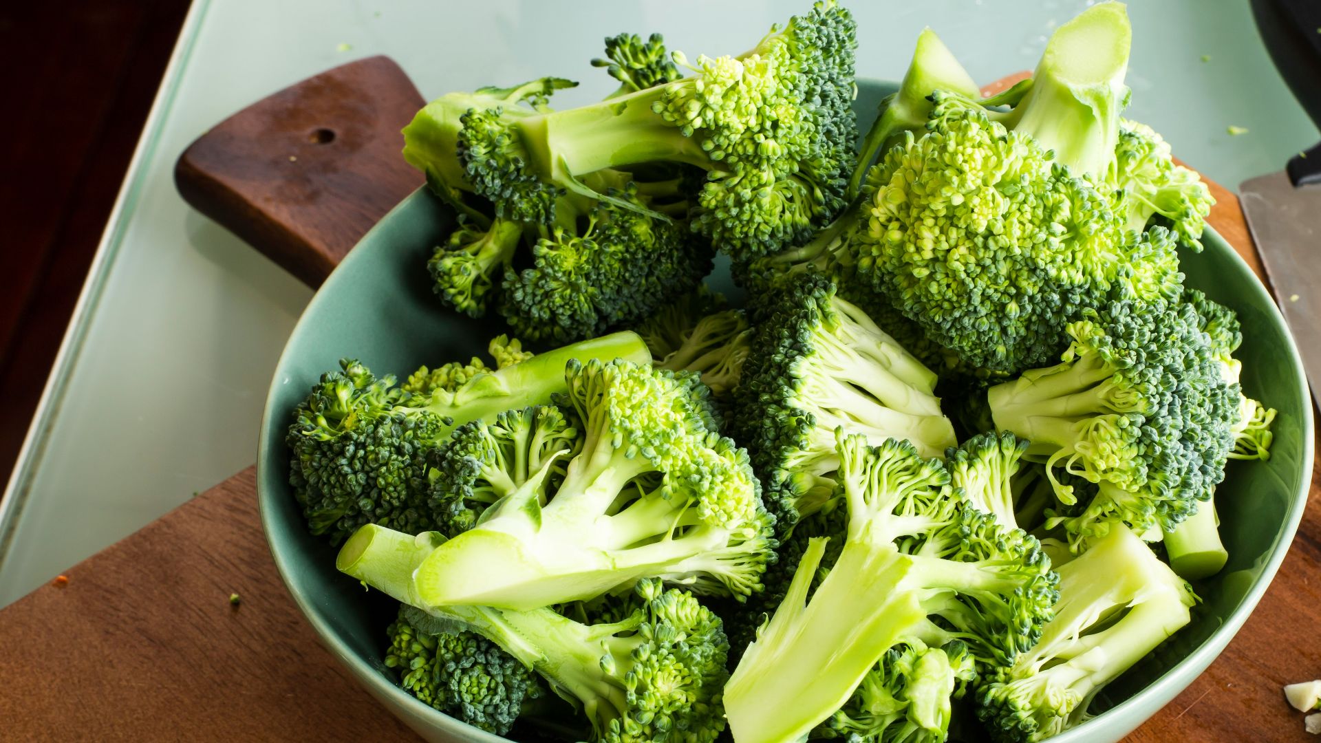 green broccoli on brown wooden chopping board