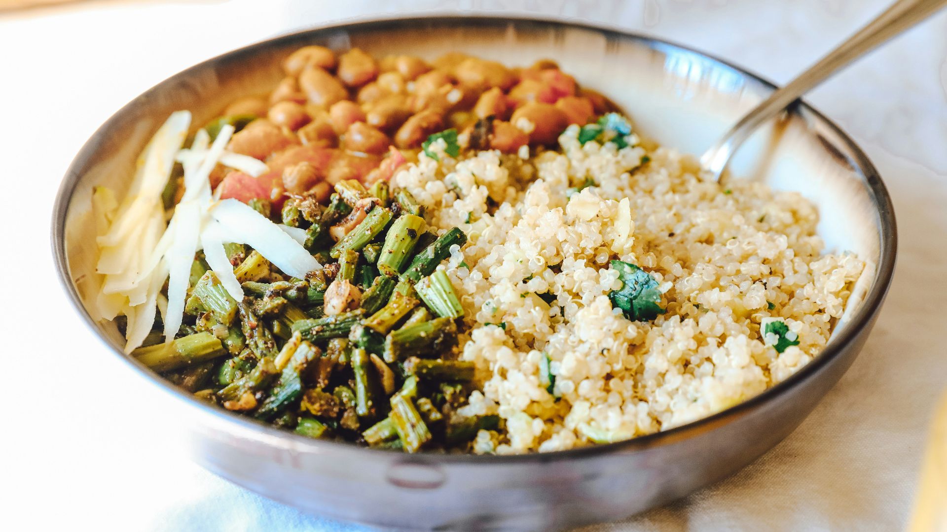 cooked rice with green peas and carrots on stainless steel bowl