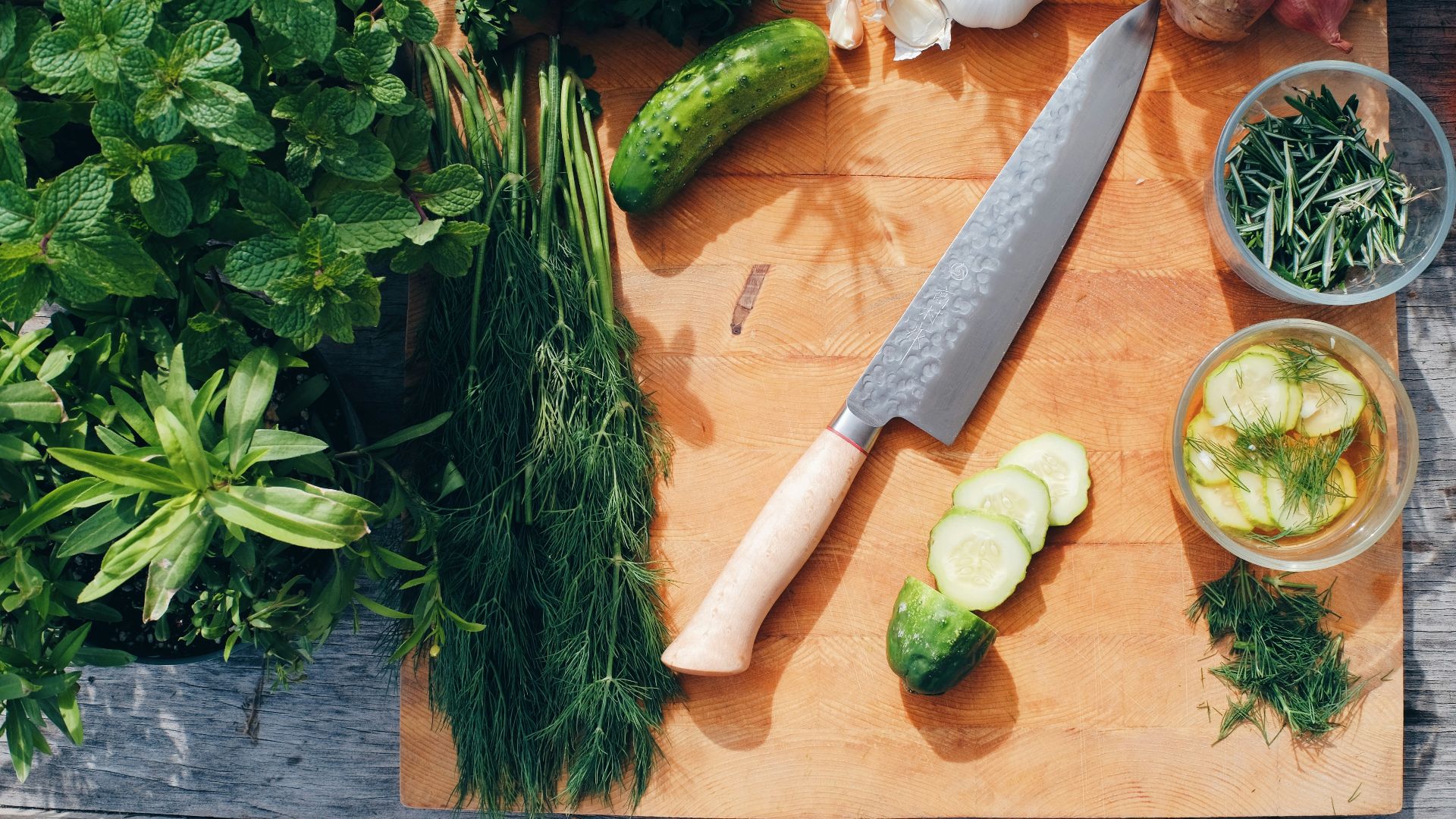 sliced cucumber and green vegetable on brown wooden chopping board
