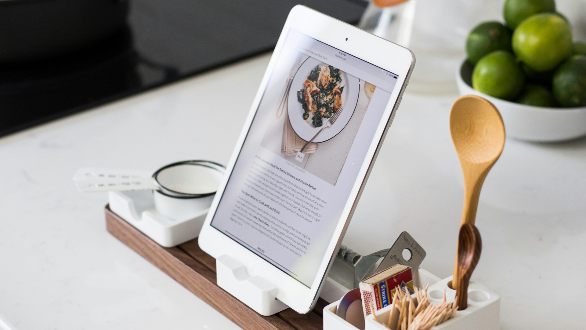 closeup photo of turned on iPad with rack on table