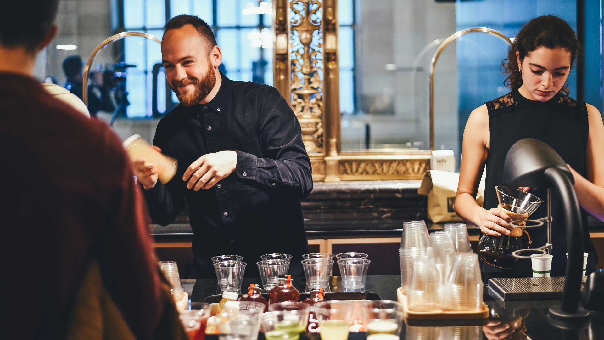 photo of man and woman mixing beverages