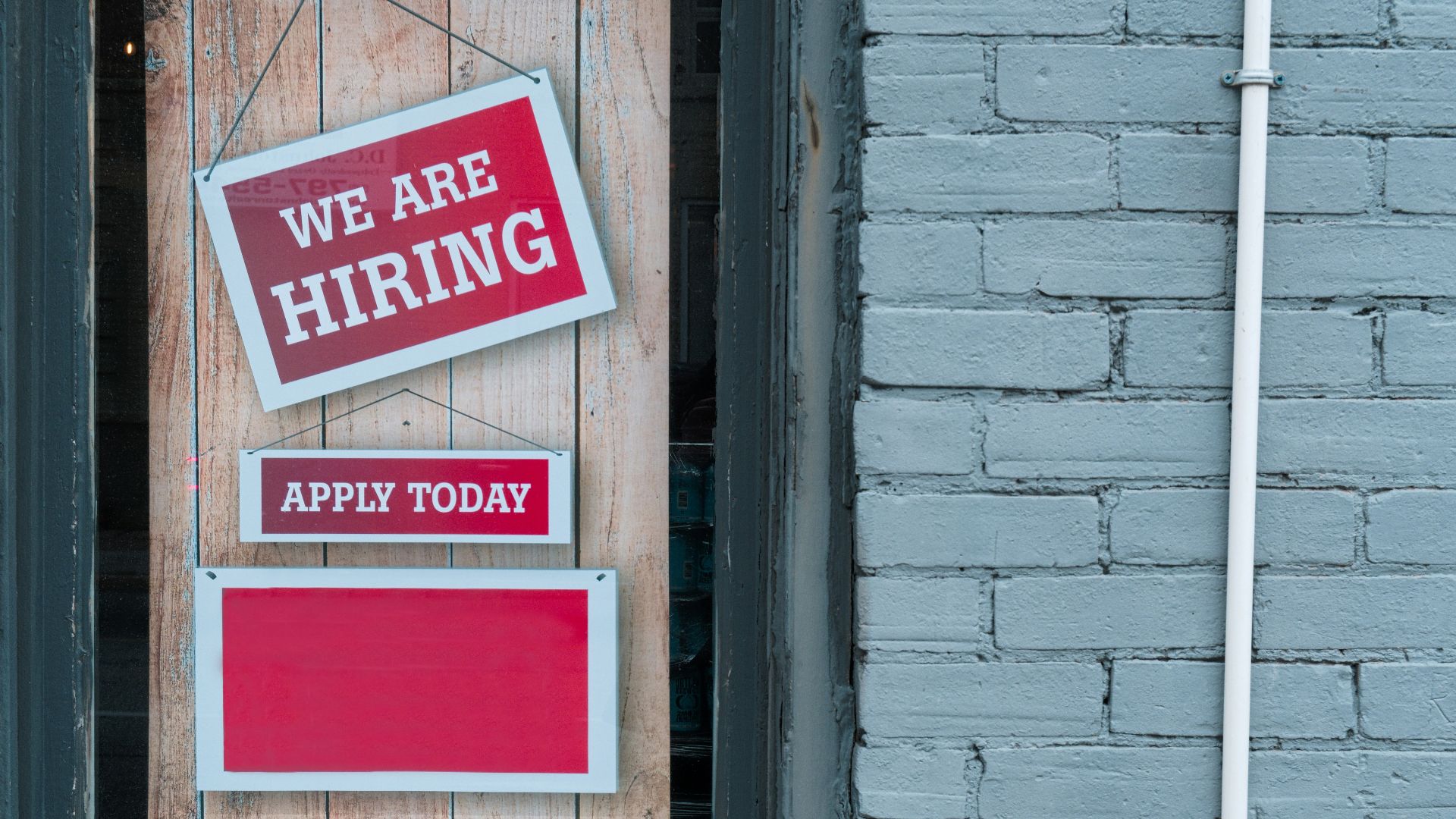 a sign that says we are hiring and apply today