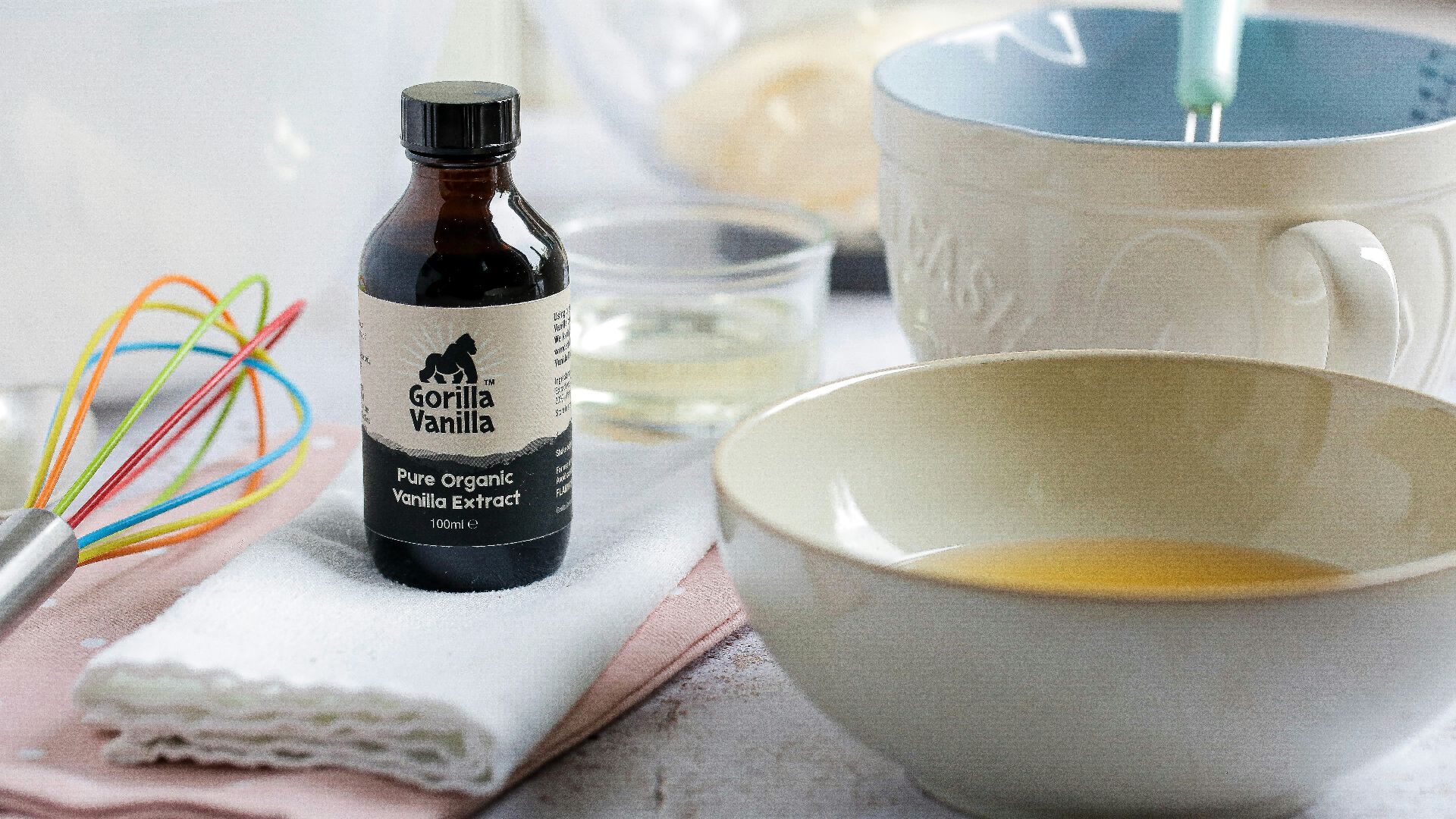 white ceramic bowl beside black glass bottle