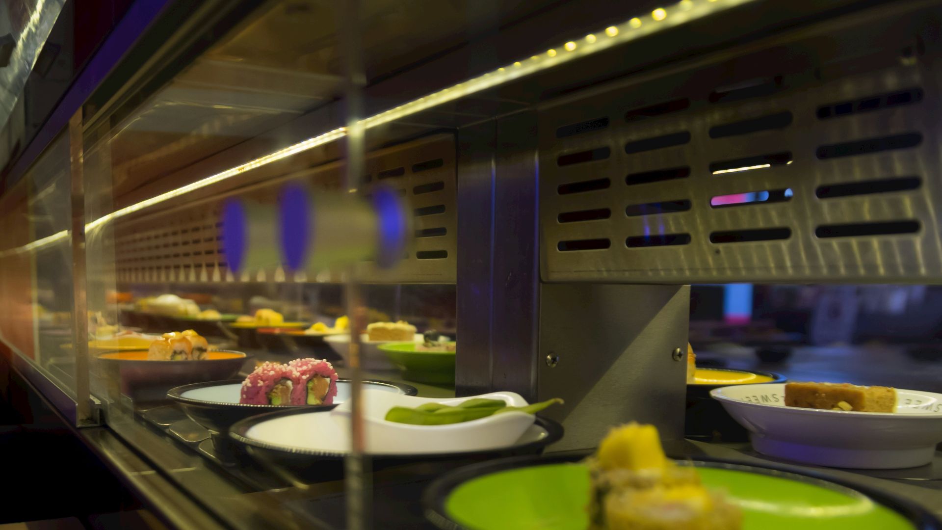 Sushi rolls moving on a conveyor belt