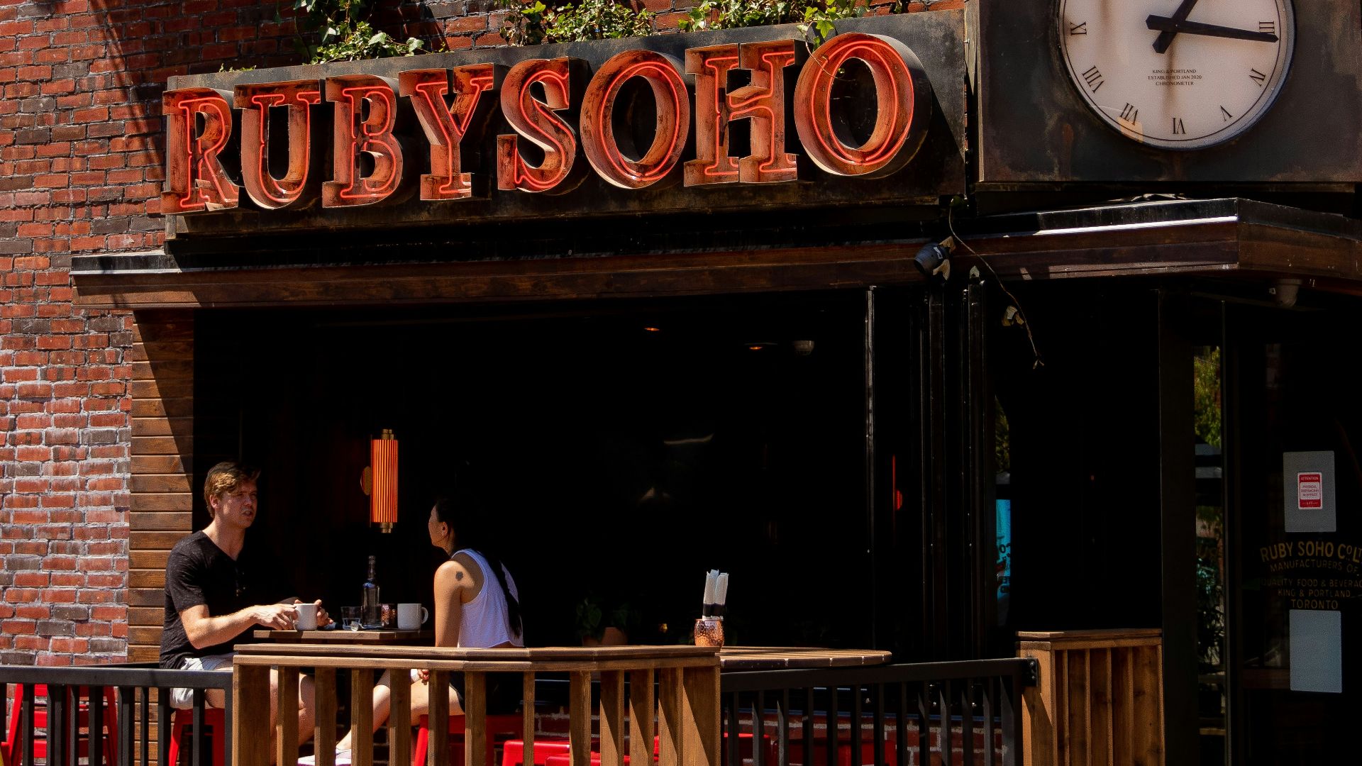 a clock on the front of a restaurant