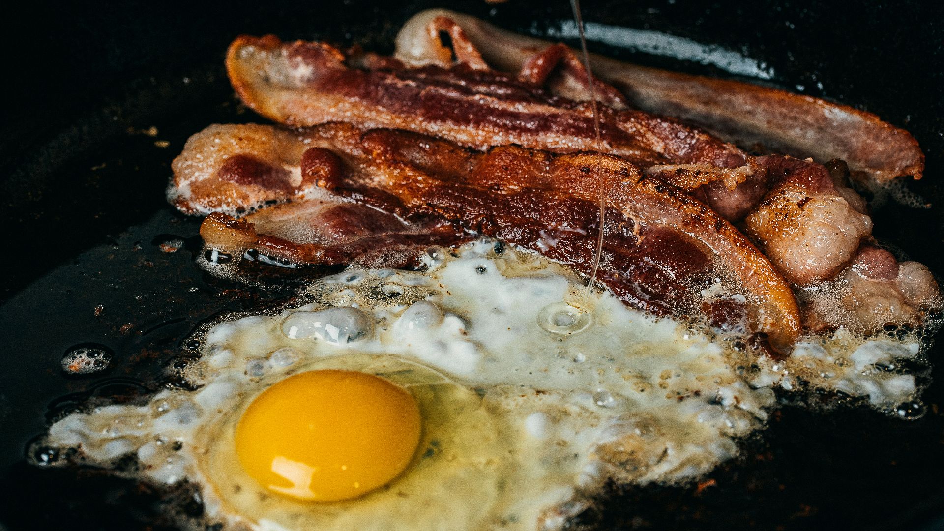fried egg on black pan