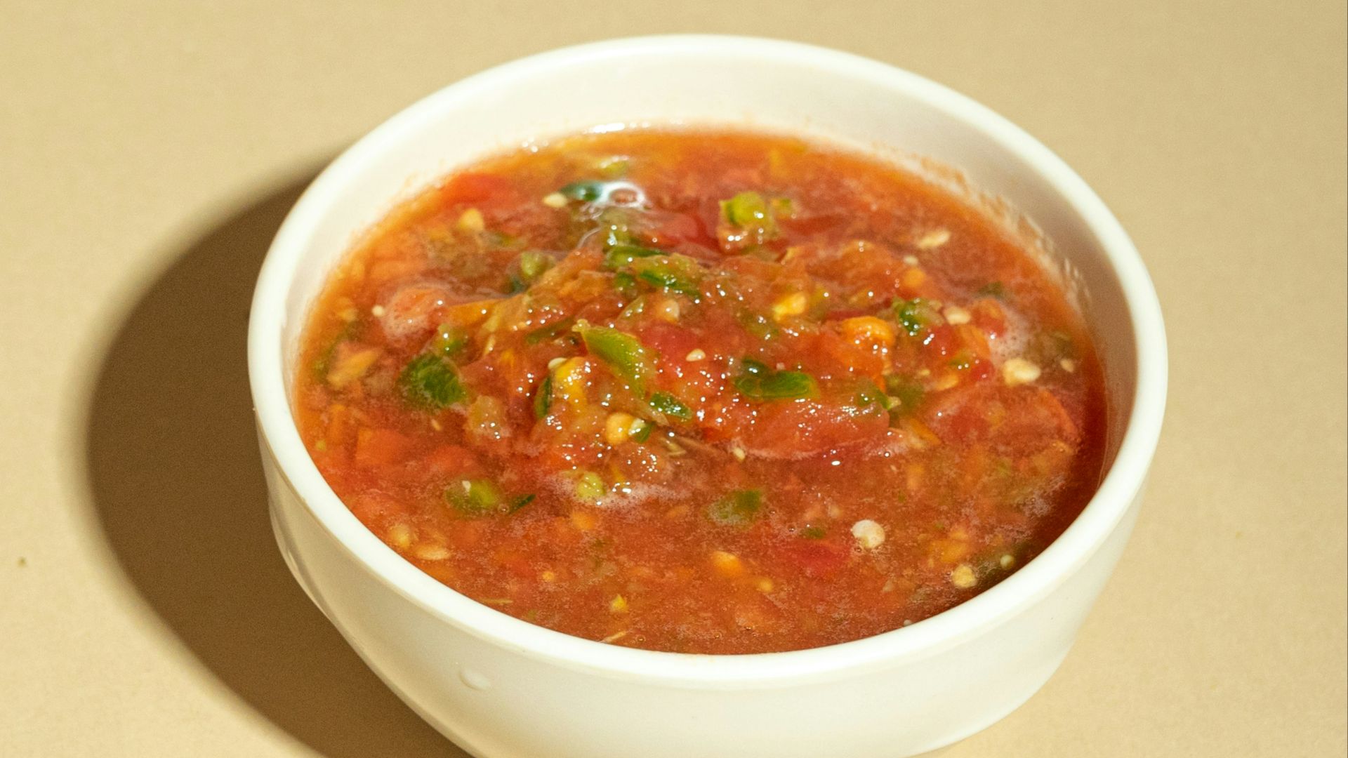 A bowl of soup is sitting on a table