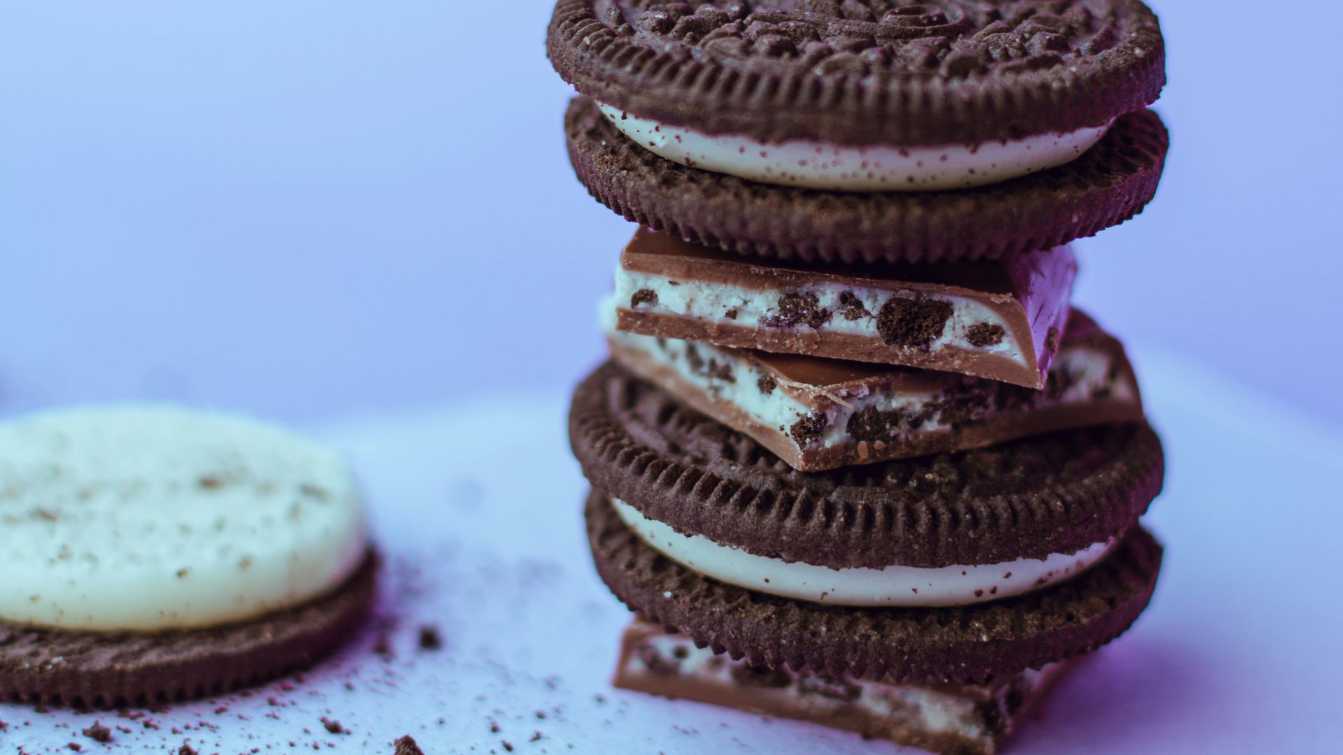 three chocolate cookies on white surface