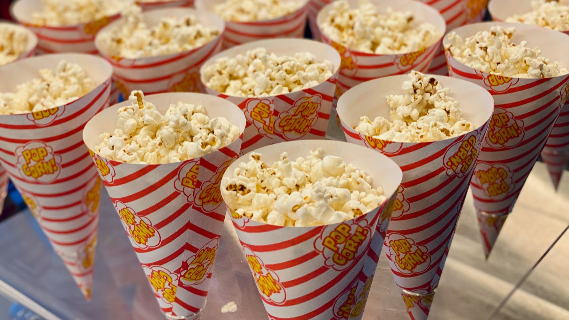 a bunch of popcorn cups that are on a table