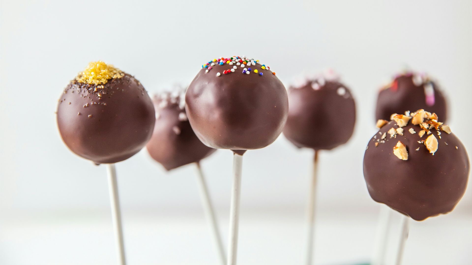 red and yellow lollipop on white surface