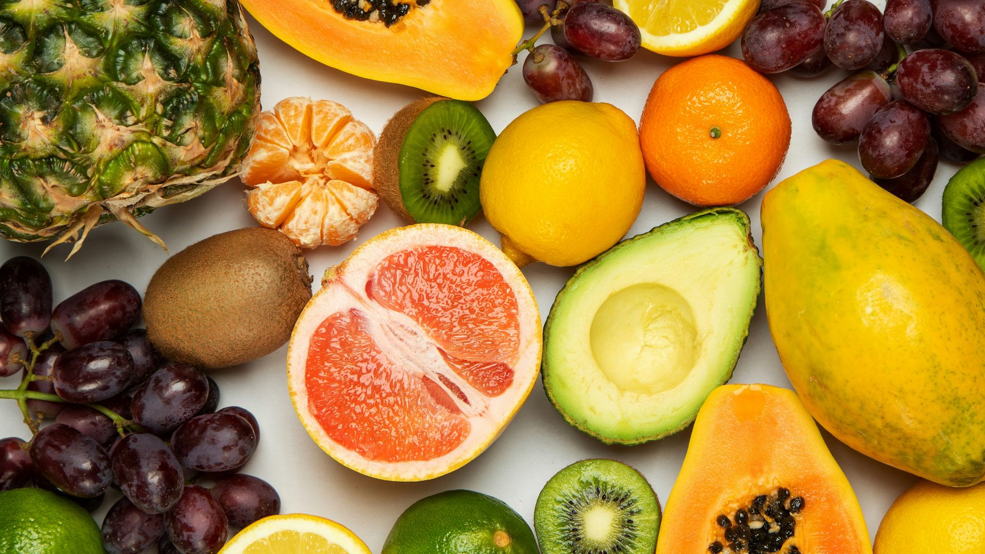 sliced orange fruit and green round fruits