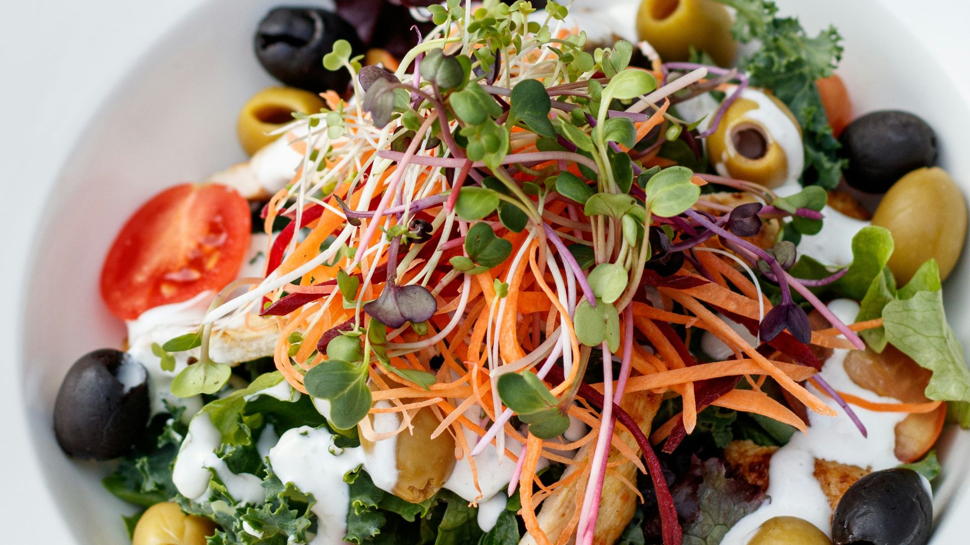 a white bowl filled with a salad on top of a wooden table