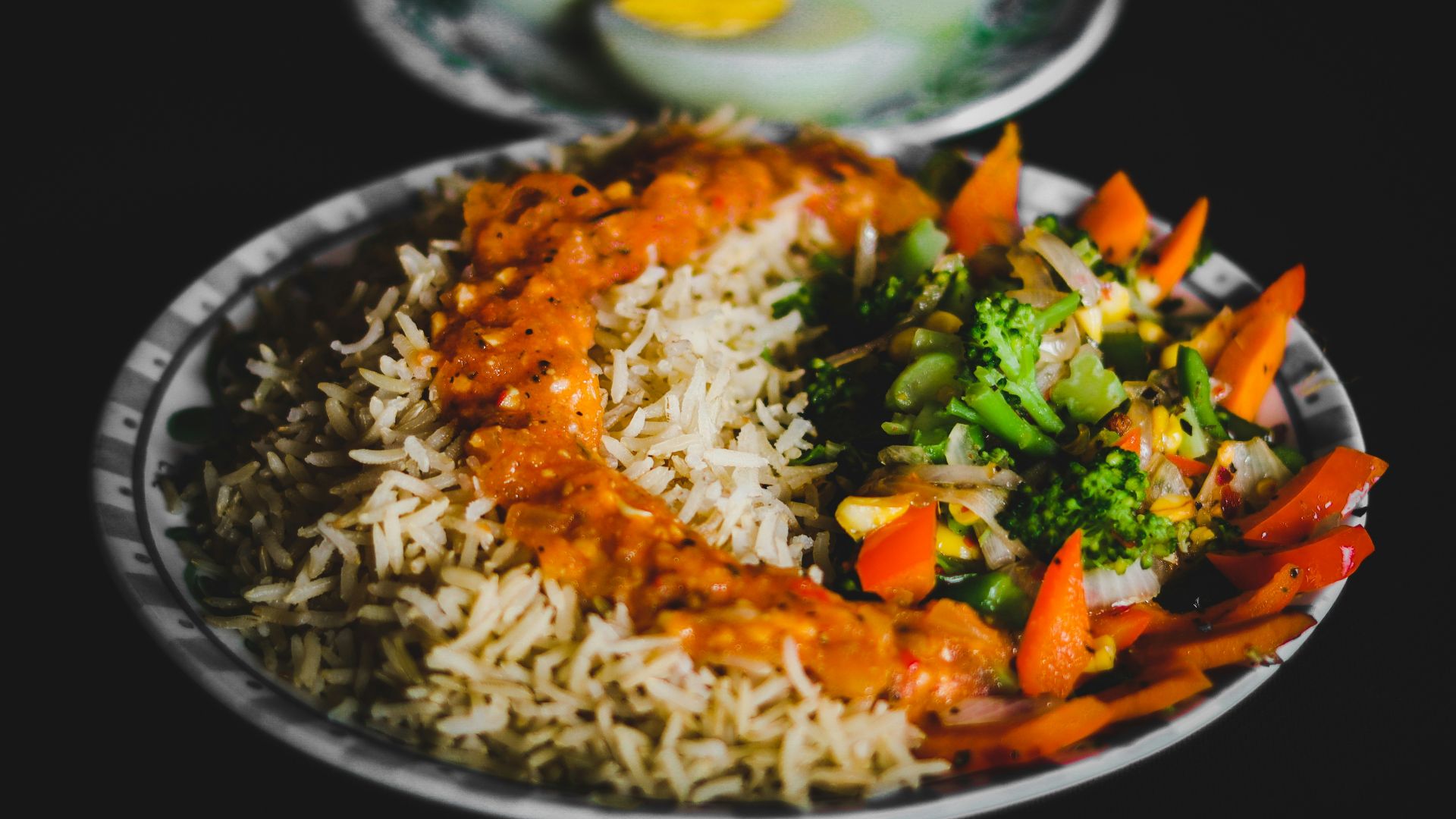 rice with sliced lemon and green vegetable on plate
