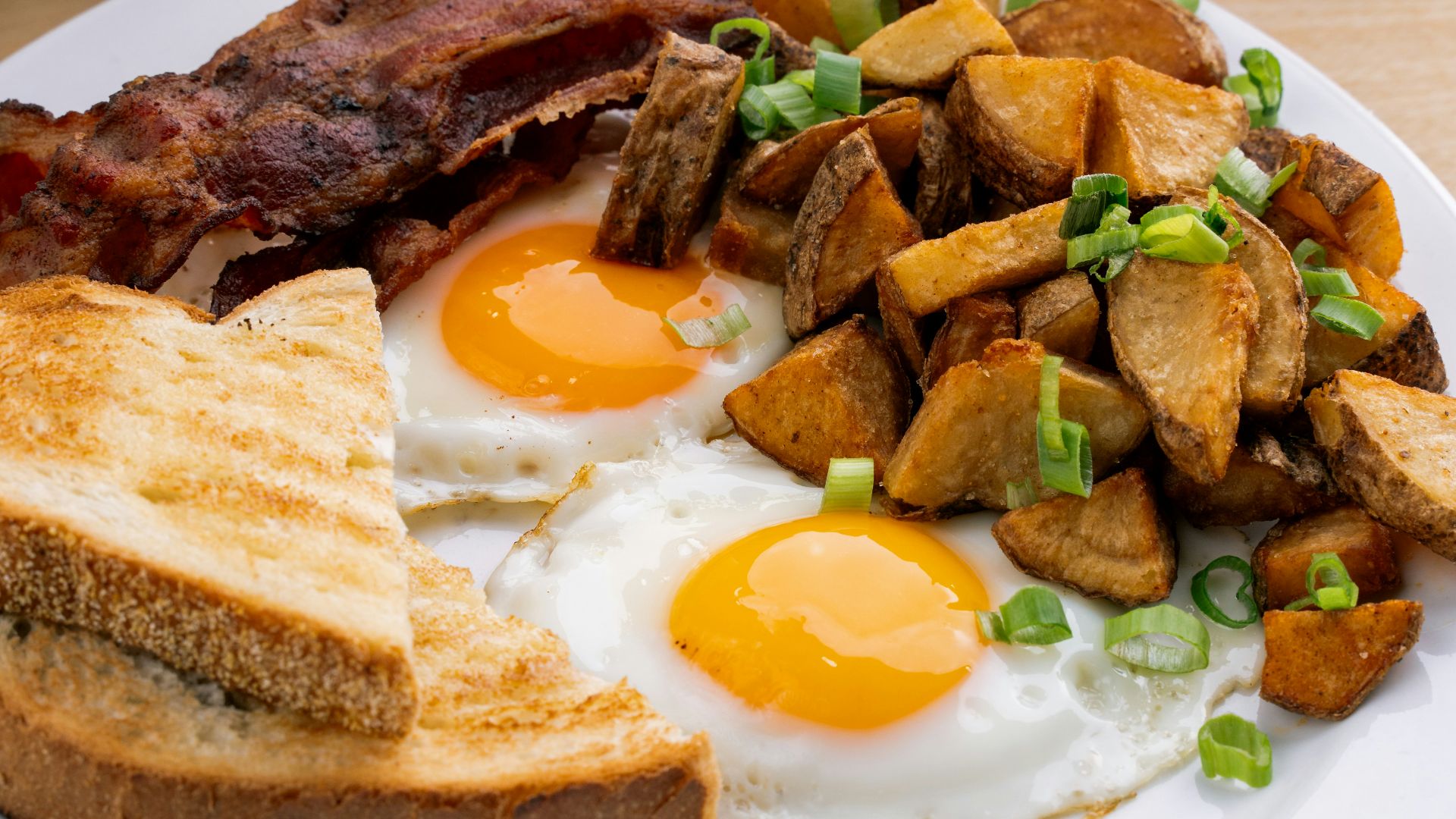 a white plate topped with eggs and toast