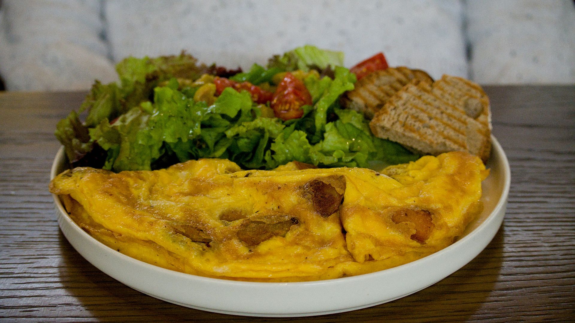 Omelette with salad and toast served on a plate
