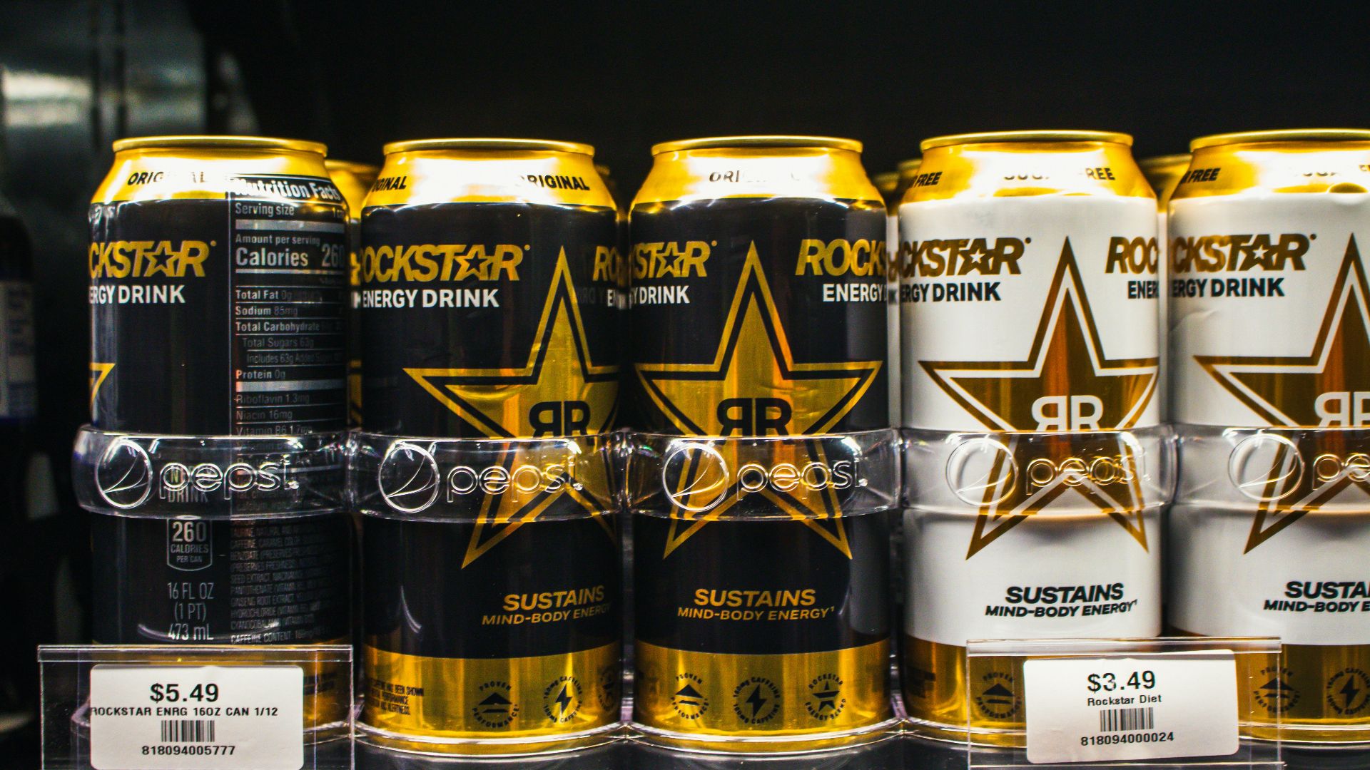 Rockstar energy drinks are displayed on a shelf.