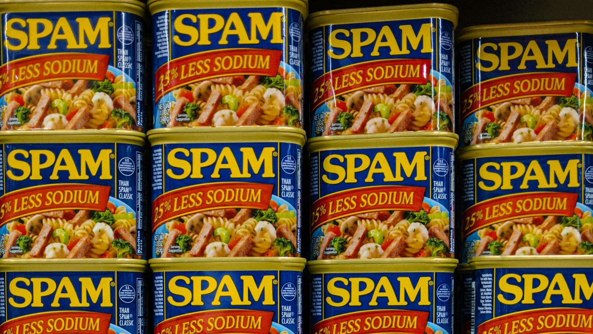 cans of spam are stacked on a shelf
