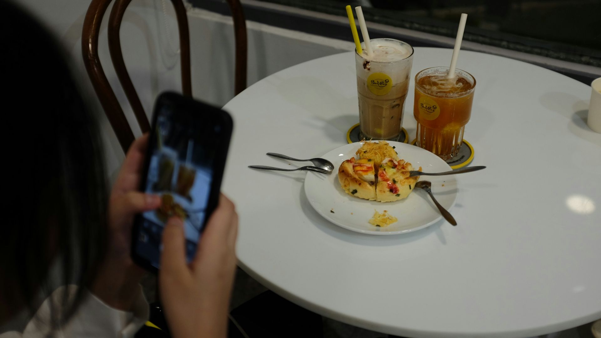 a person taking a picture of food on a table