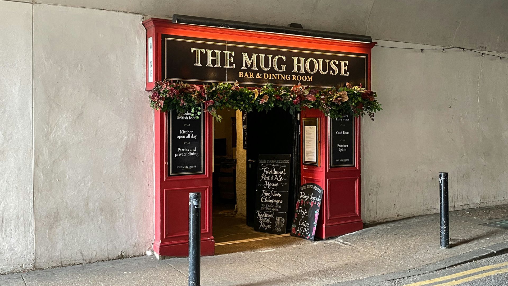 A building with a sign that says the mug house