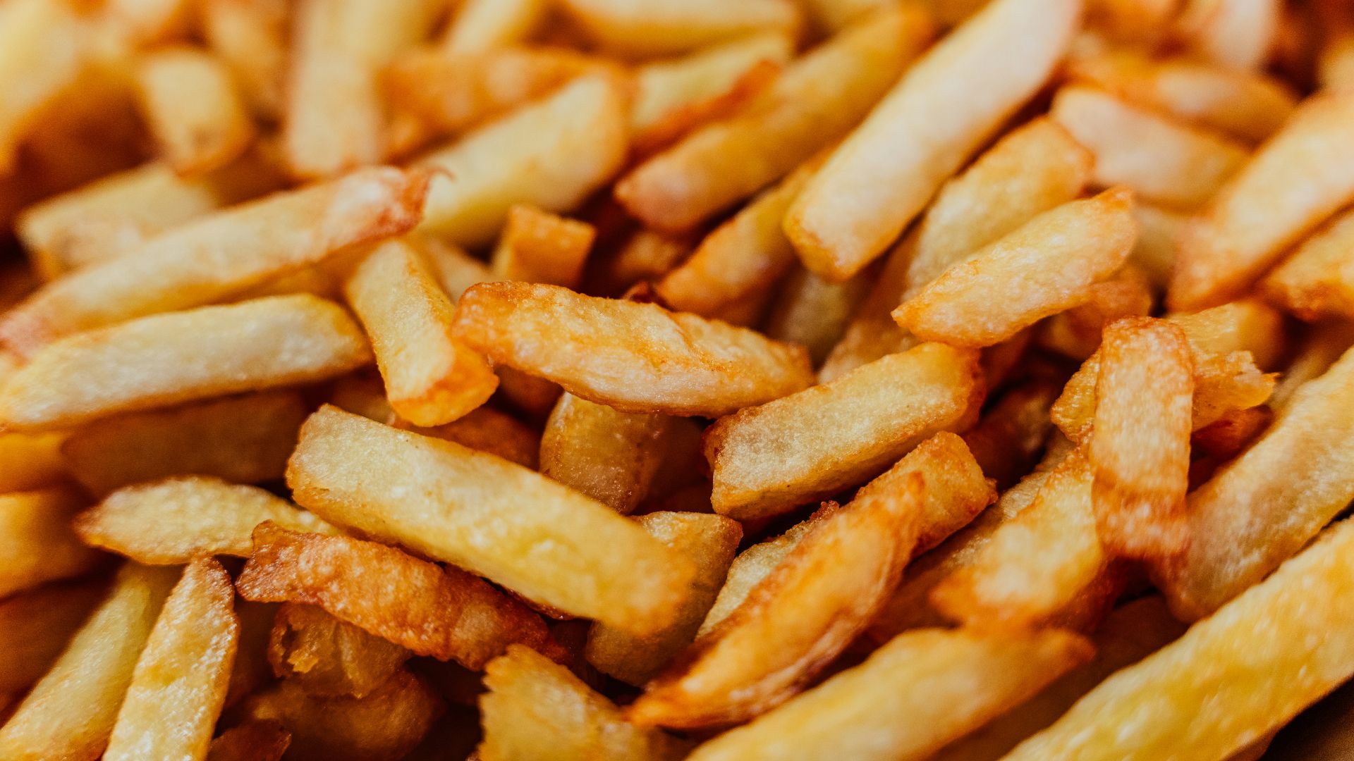 a pile of french fries sitting on top of a table