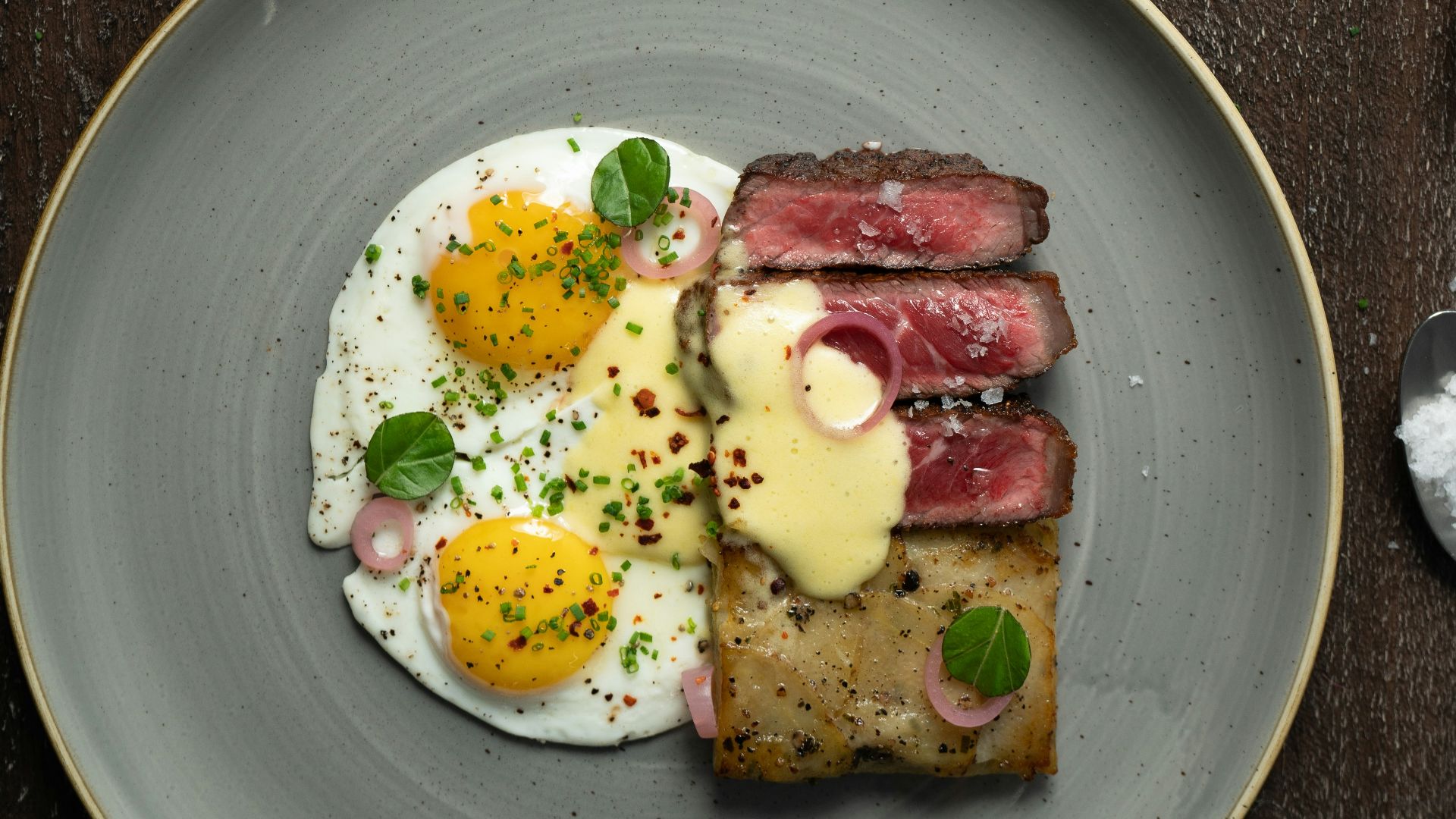 a plate of food with eggs and meat on it