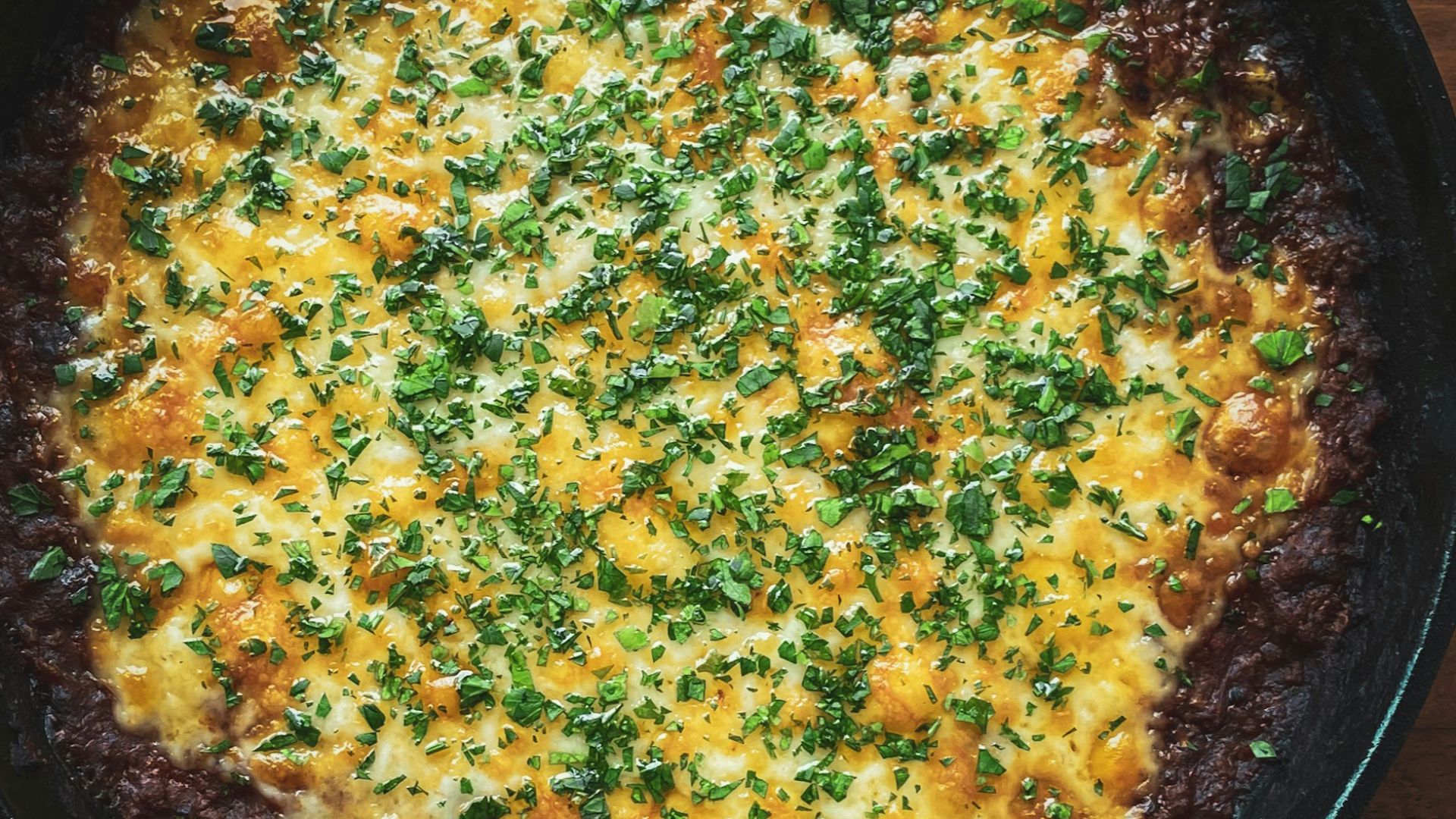 black frying pan on brown wooden table