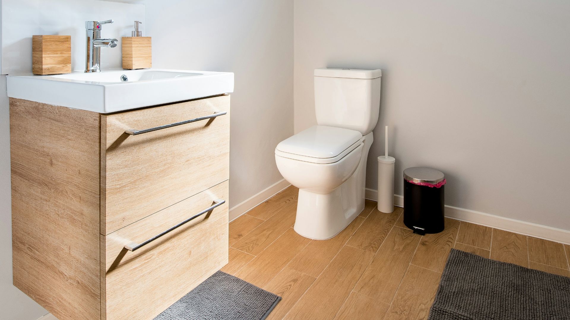 white ceramic toilet bowl near vanity combo