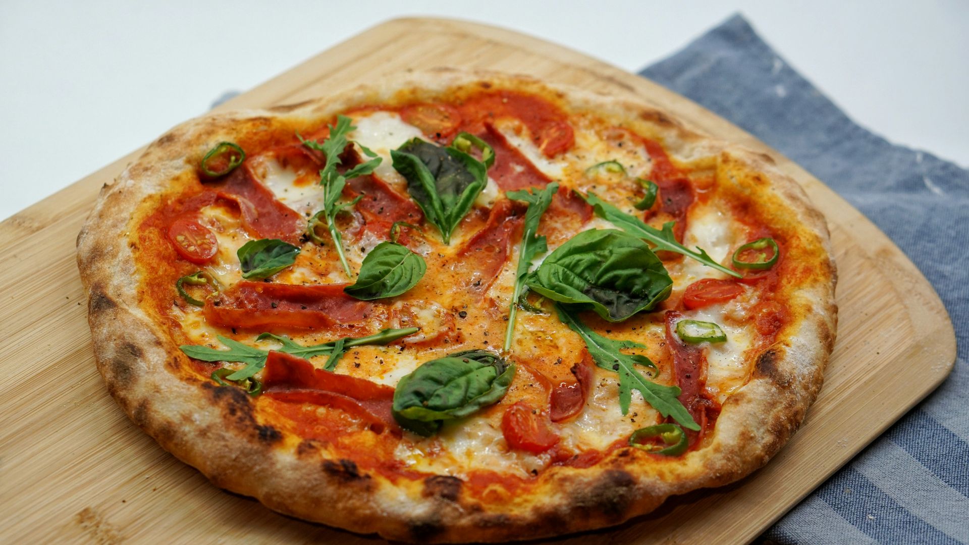 pizza with green leaves and red sauce