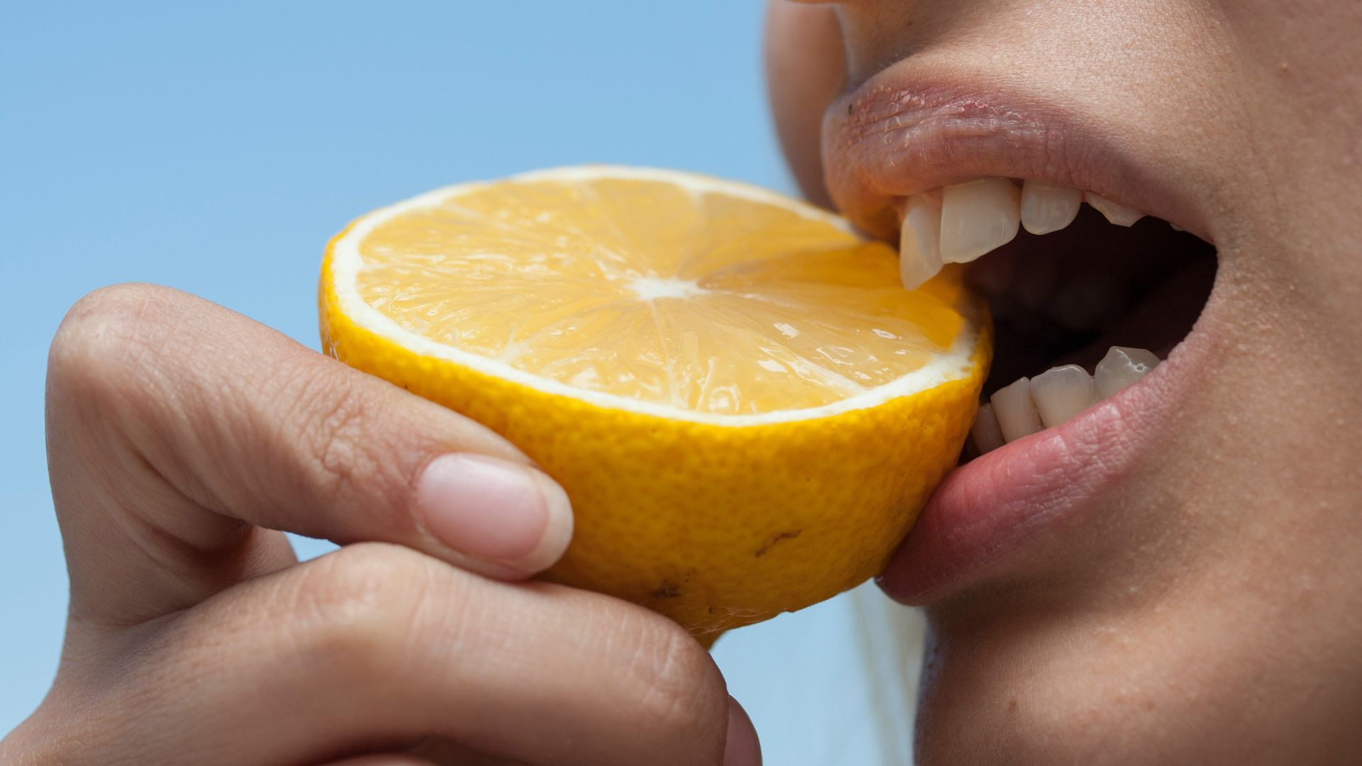 person holding orange fruit during daytime